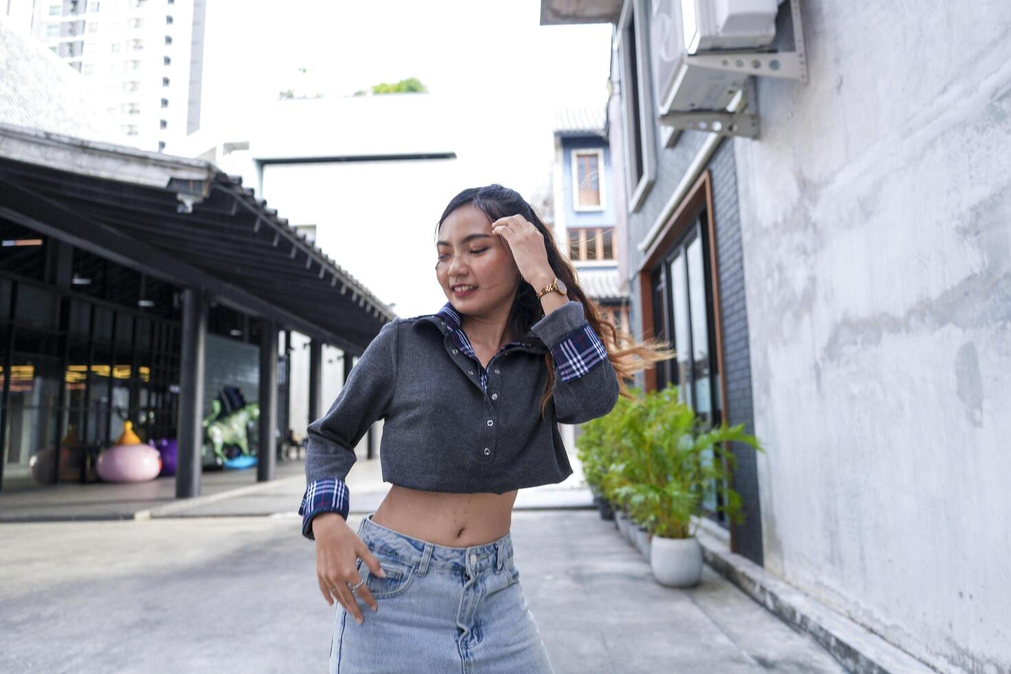 Asian women do freestyle hip hop and breakdancing in a public space in the middle of the city. With a cheerful and happy attitude photo