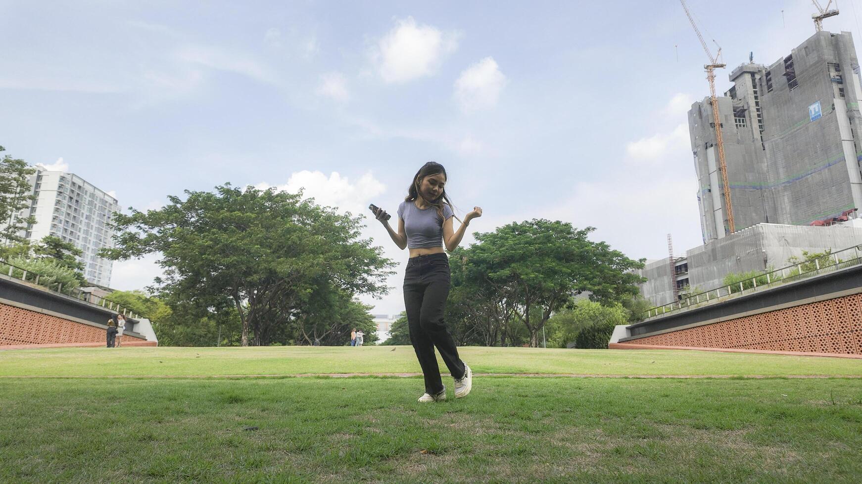 Asian women do freestyle hip hop and breakdancing in a public space in the middle of the city. With a cheerful and happy attitude photo