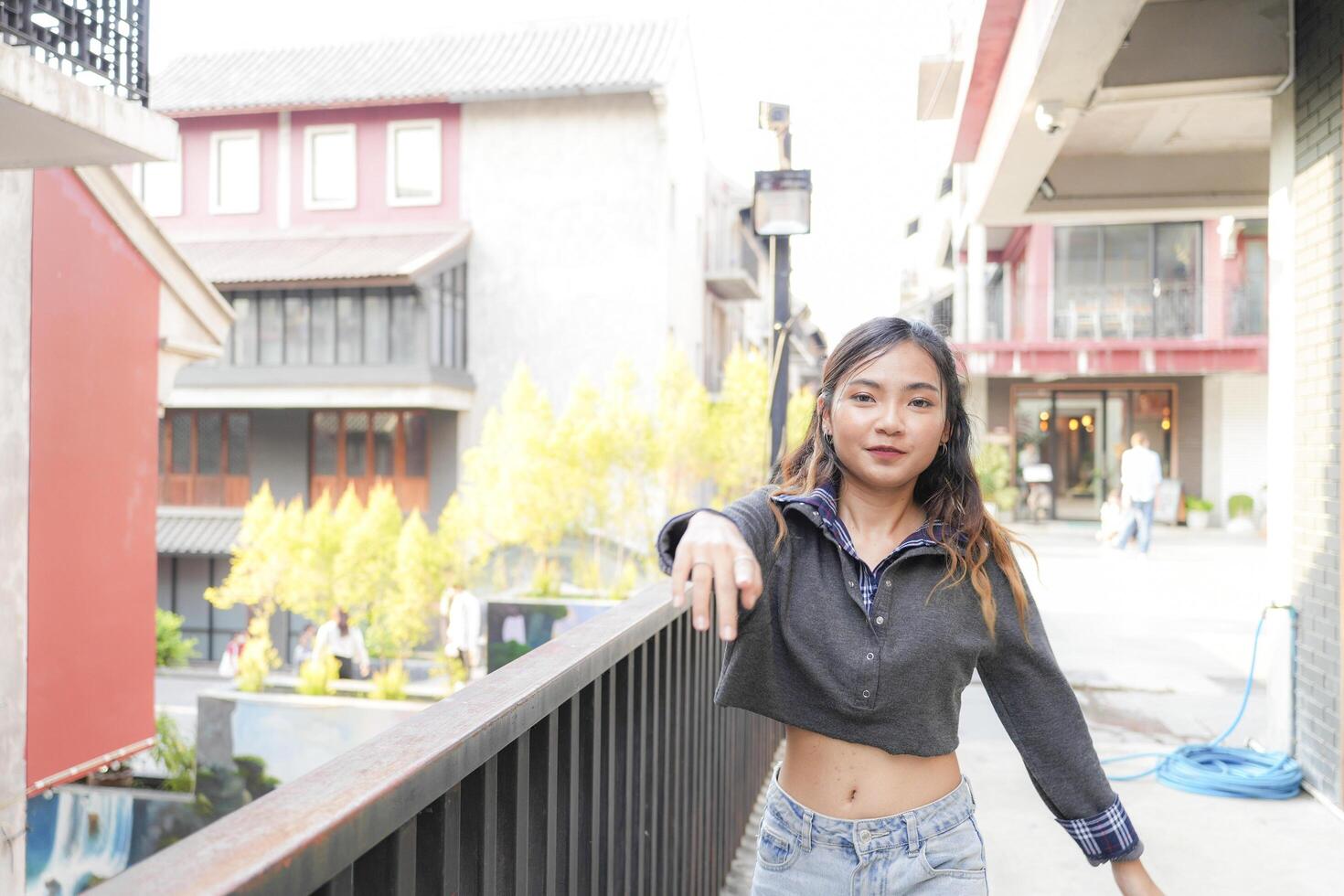 Asian women do freestyle hip hop and breakdancing in a public space in the middle of the city. With a cheerful and happy attitude photo