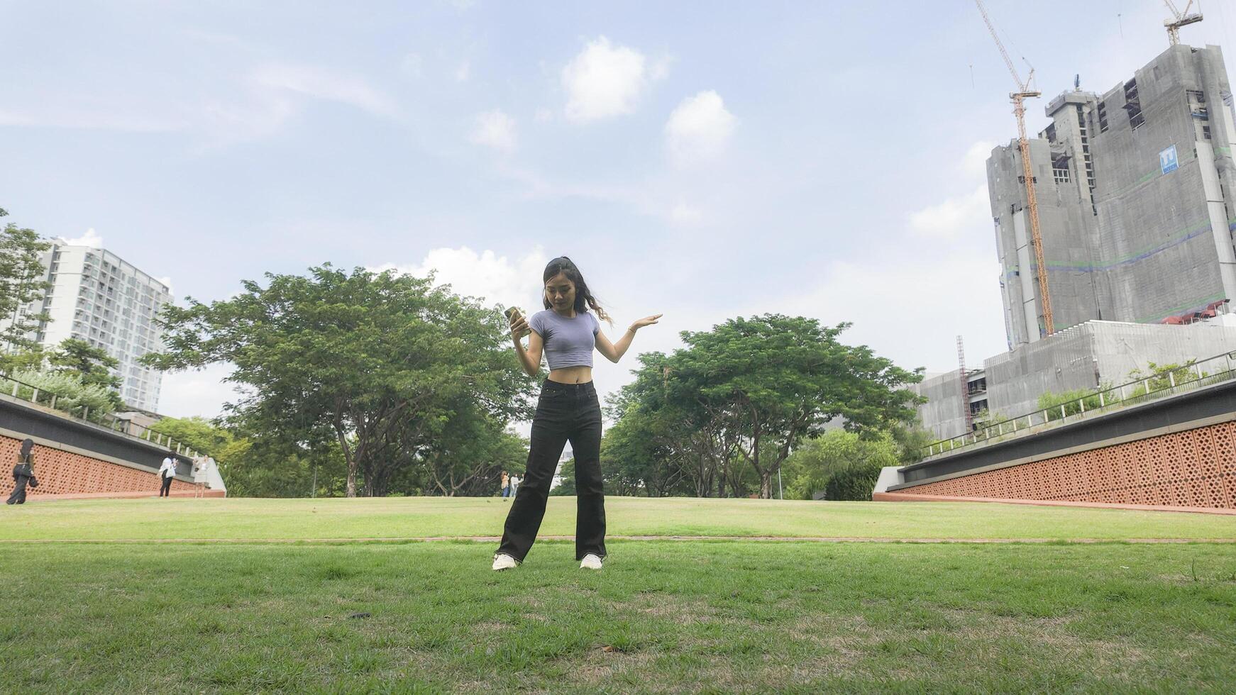 Asian women do freestyle hip hop and breakdancing in a public space in the middle of the city. With a cheerful and happy attitude photo