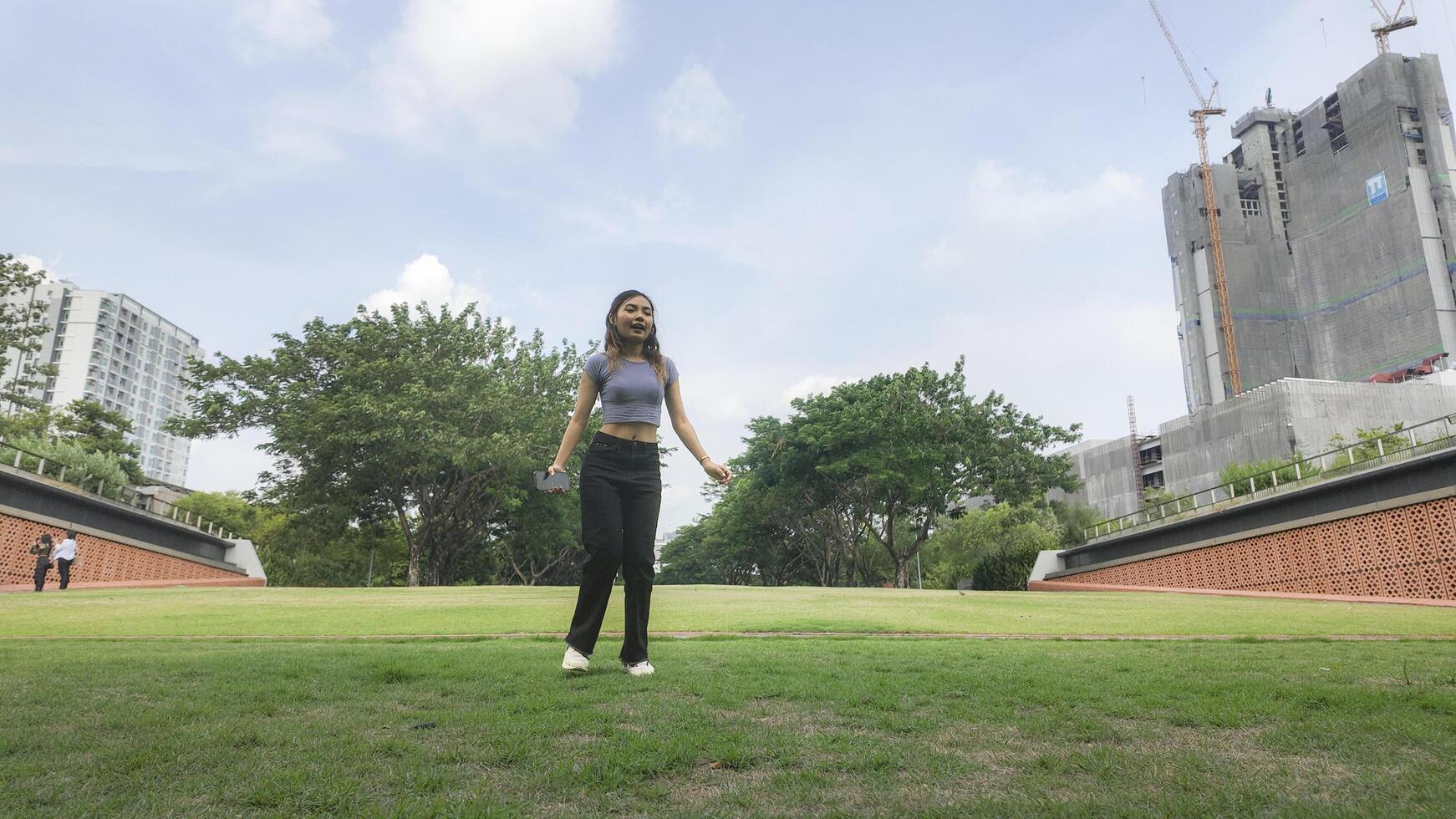 Asian women do freestyle hip hop and breakdancing in a public space in the middle of the city. With a cheerful and happy attitude photo