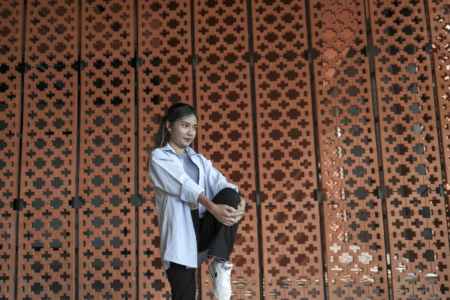 Asian women do freestyle hip hop and breakdancing in a public space in the middle of the city. With a cheerful and happy attitude photo
