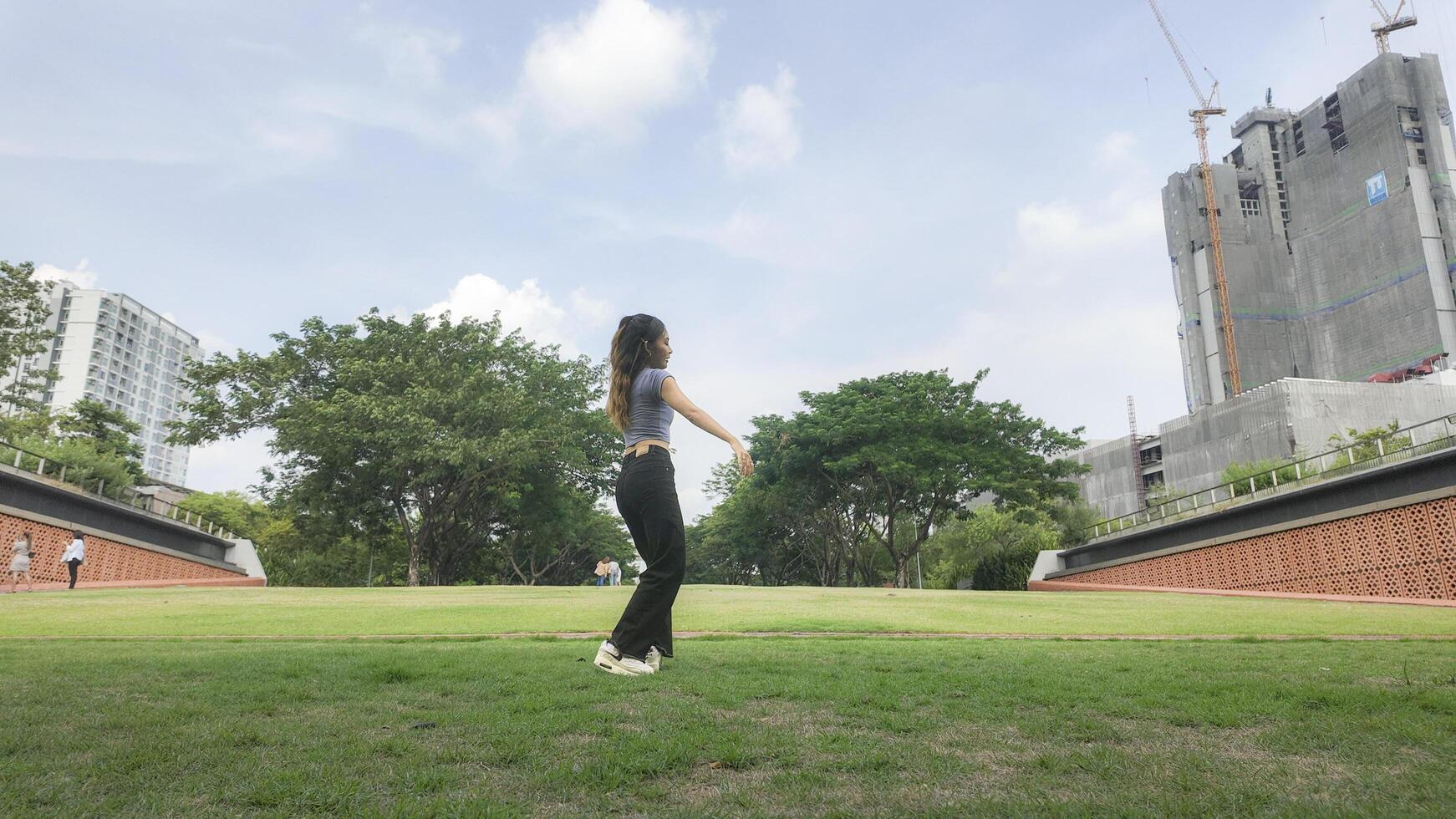 Asian women do freestyle hip hop and breakdancing in a public space in the middle of the city. With a cheerful and happy attitude photo