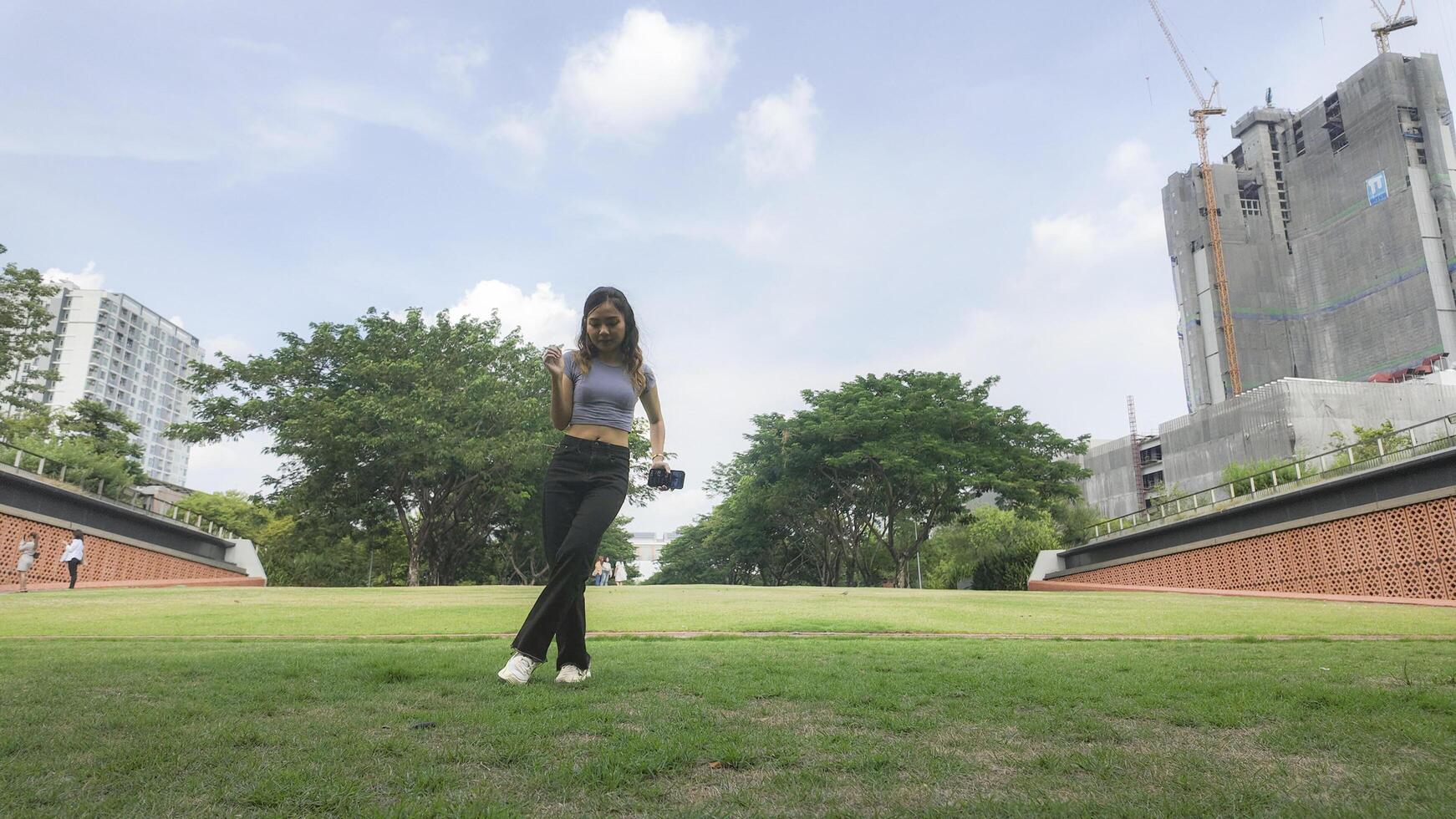Asian women do freestyle hip hop and breakdancing in a public space in the middle of the city. With a cheerful and happy attitude photo