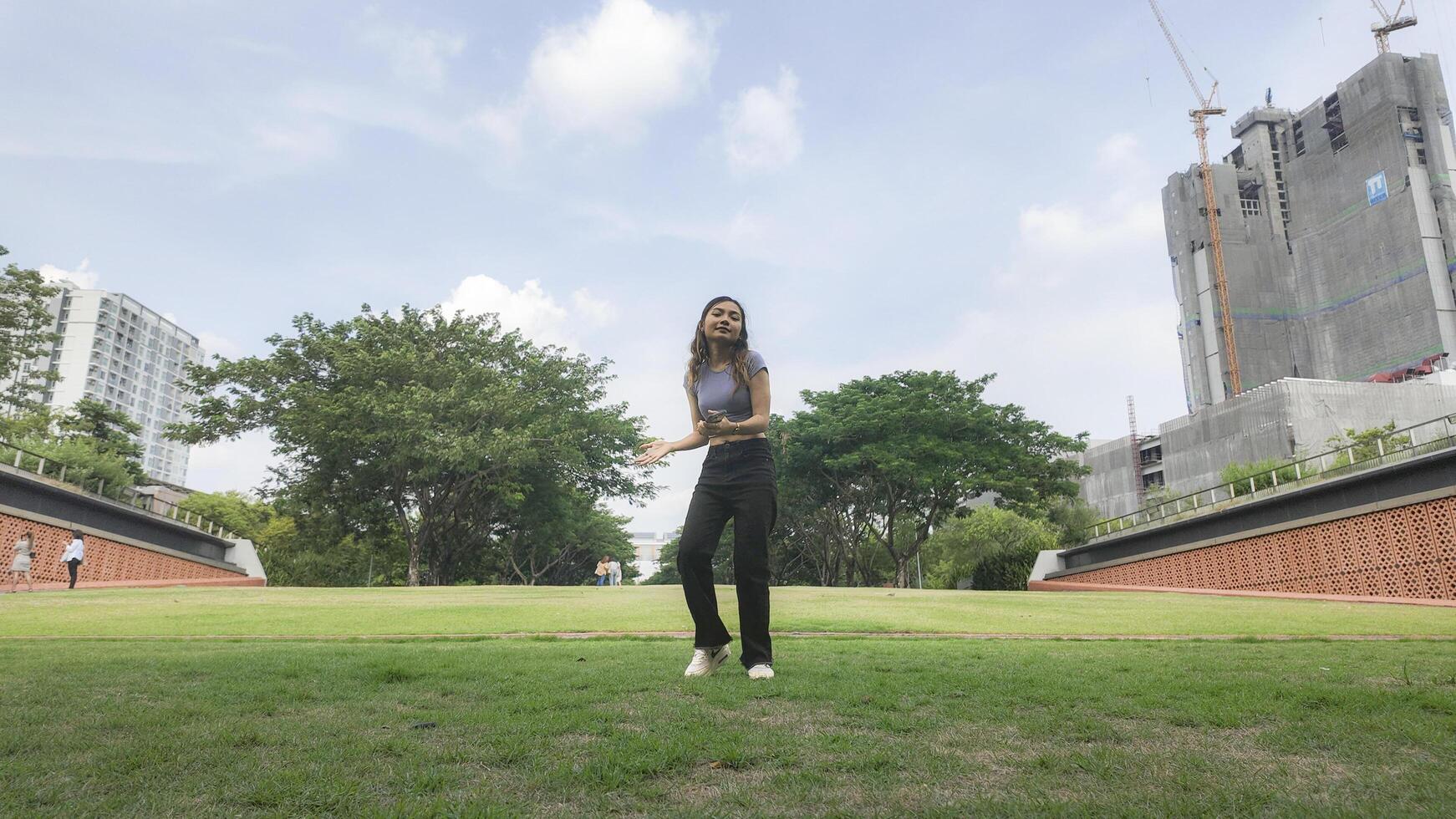 Asian women do freestyle hip hop and breakdancing in a public space in the middle of the city. With a cheerful and happy attitude photo