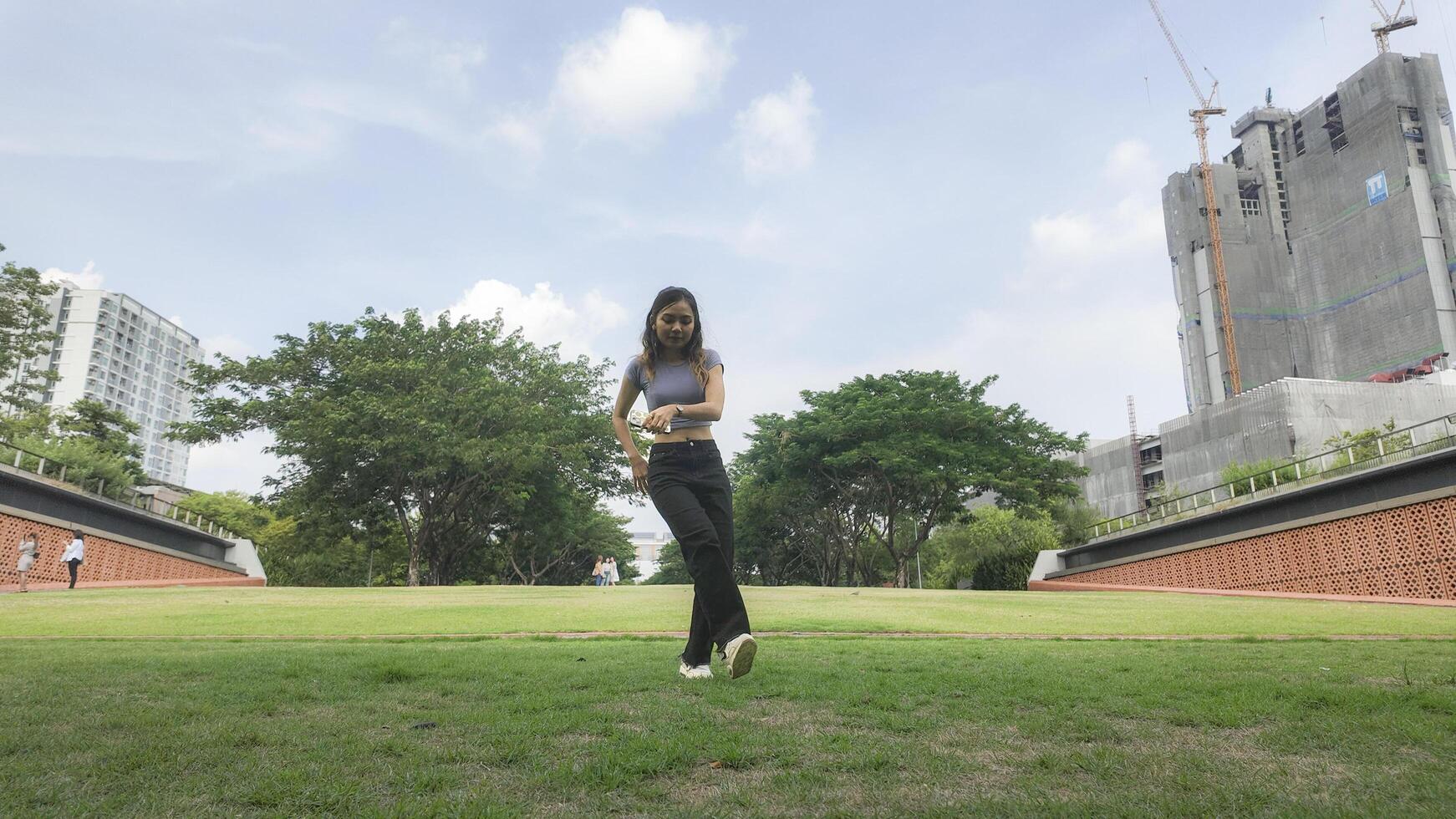 Asian women do freestyle hip hop and breakdancing in a public space in the middle of the city. With a cheerful and happy attitude photo