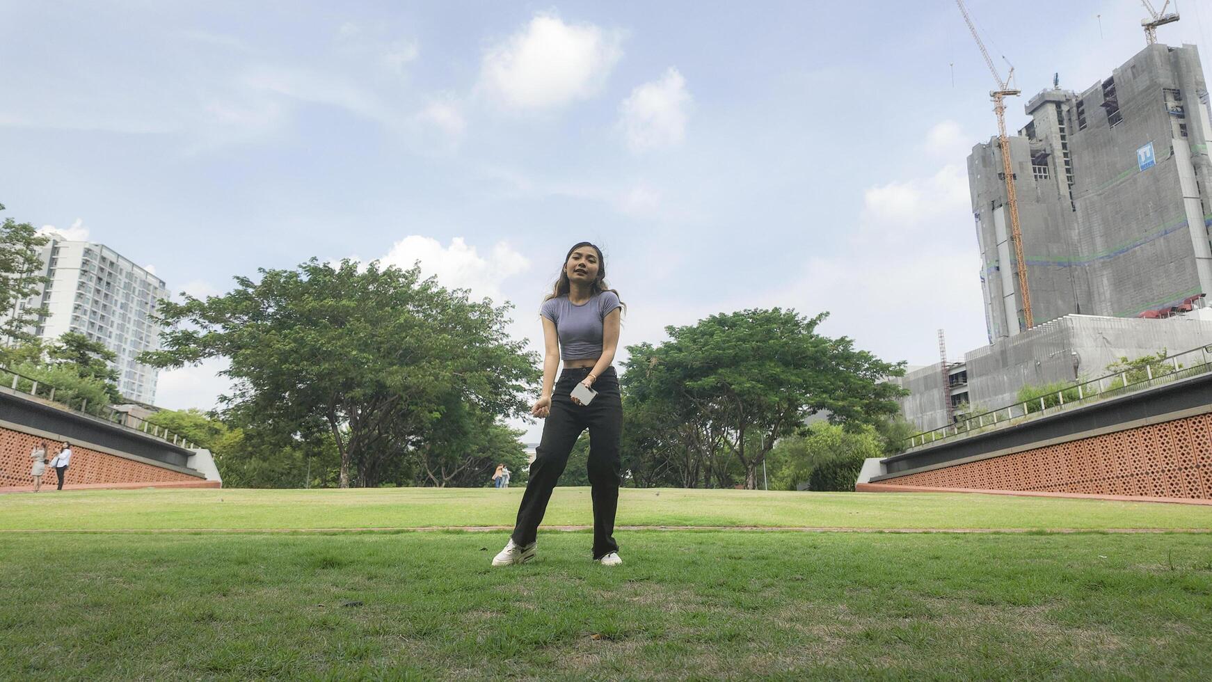 Asian women do freestyle hip hop and breakdancing in a public space in the middle of the city. With a cheerful and happy attitude photo