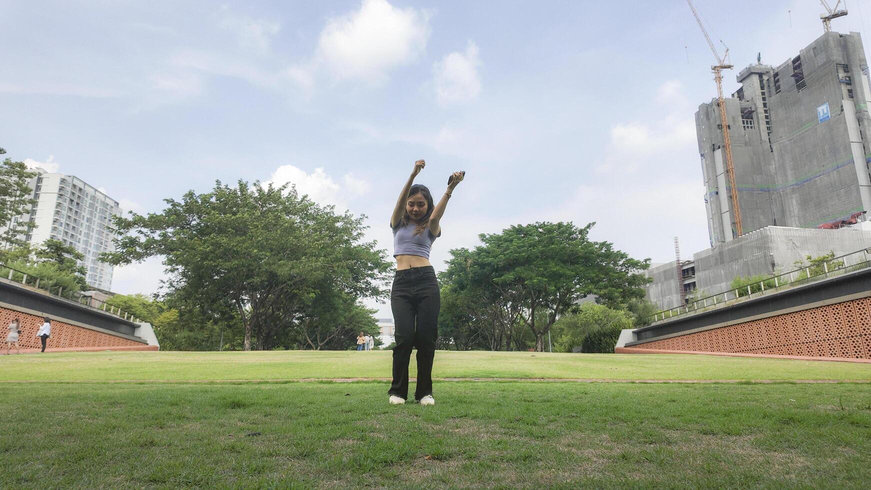 Asian women do freestyle hip hop and breakdancing in a public space in the middle of the city. With a cheerful and happy attitude photo