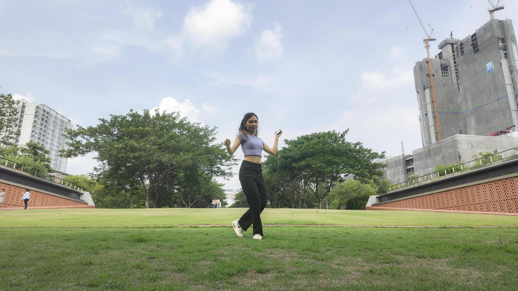 Asian women do freestyle hip hop and breakdancing in a public space in the middle of the city. With a cheerful and happy attitude photo