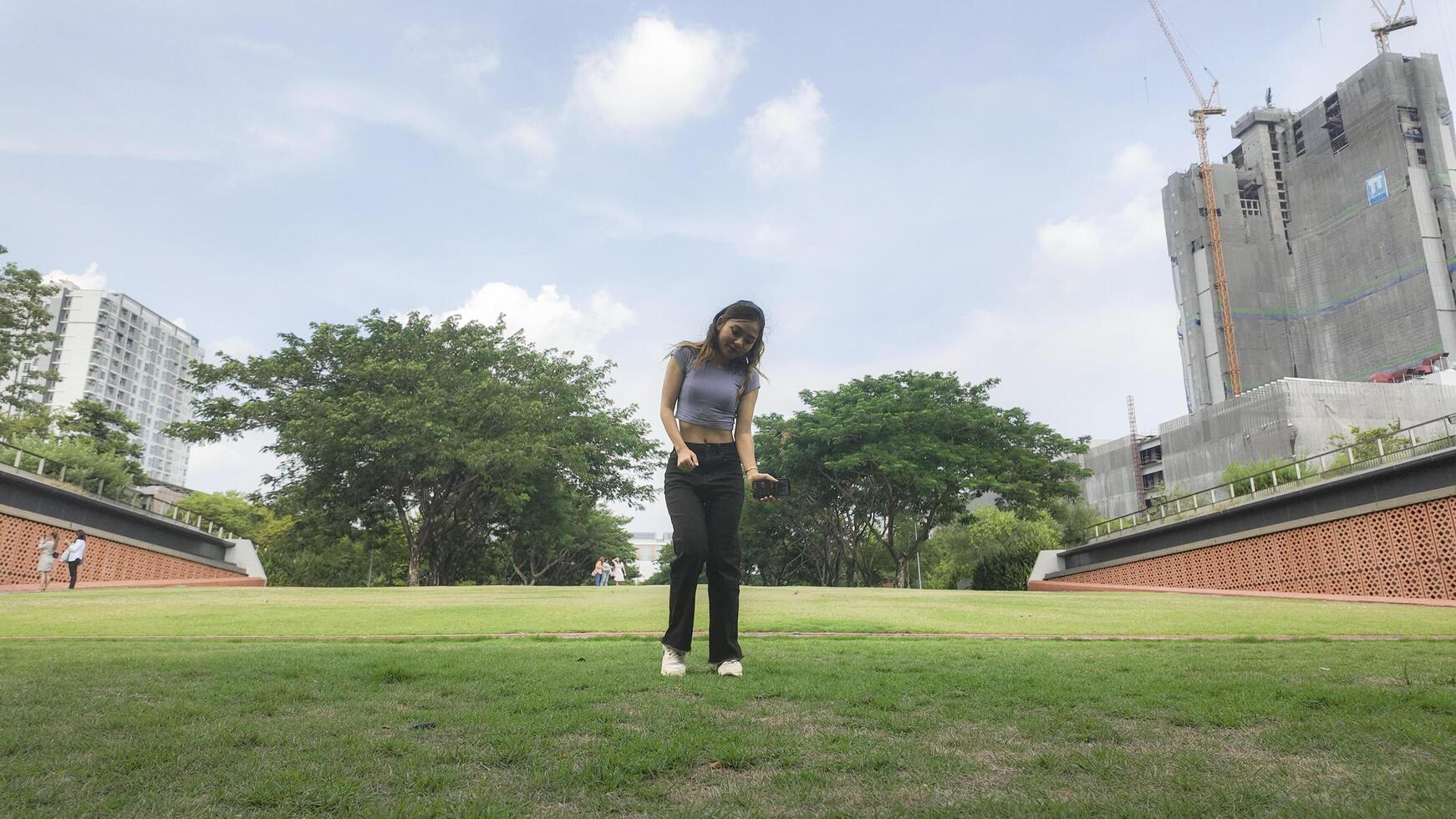 Asian women do freestyle hip hop and breakdancing in a public space in the middle of the city. With a cheerful and happy attitude photo