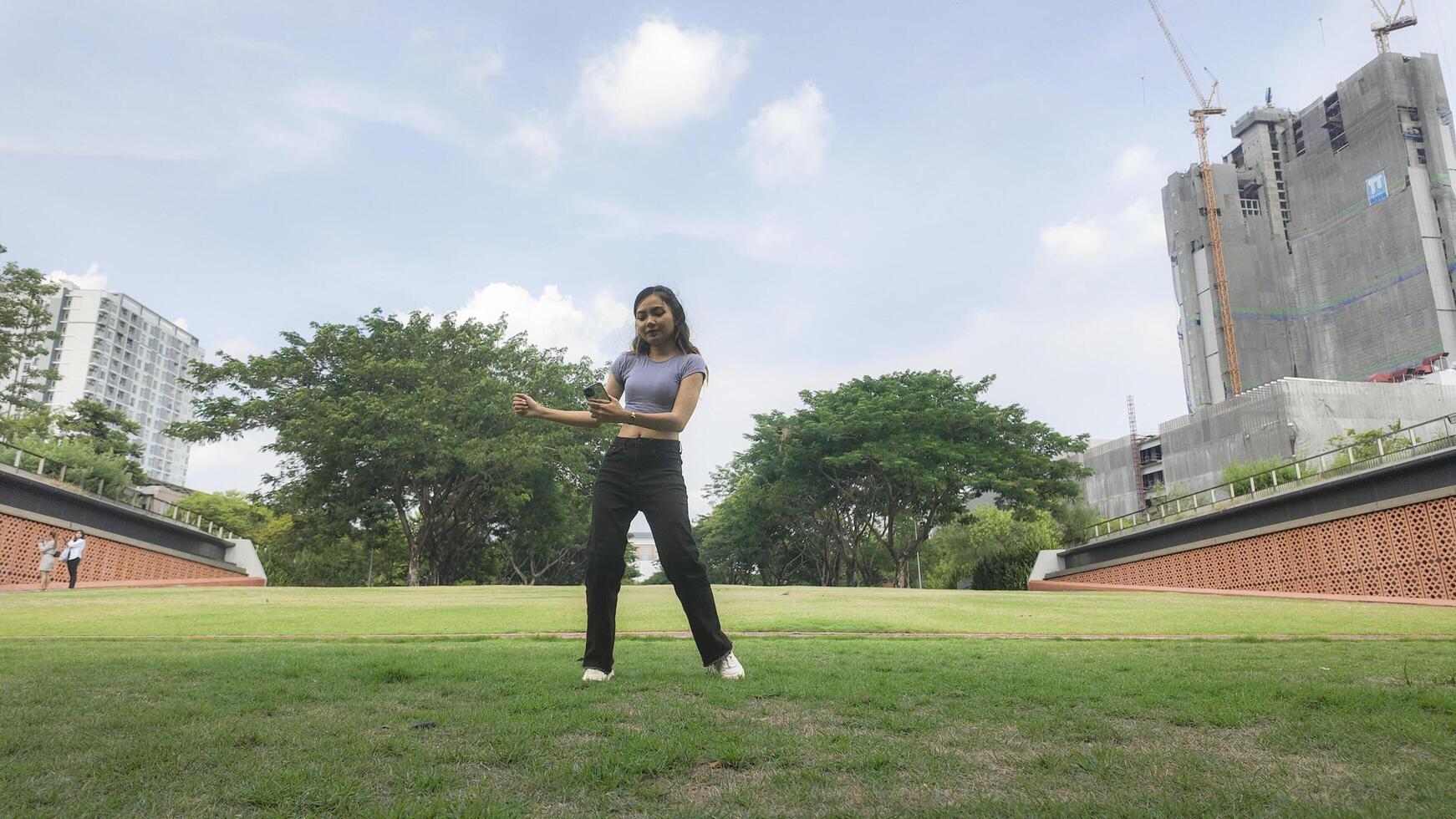 Asian women do freestyle hip hop and breakdancing in a public space in the middle of the city. With a cheerful and happy attitude photo