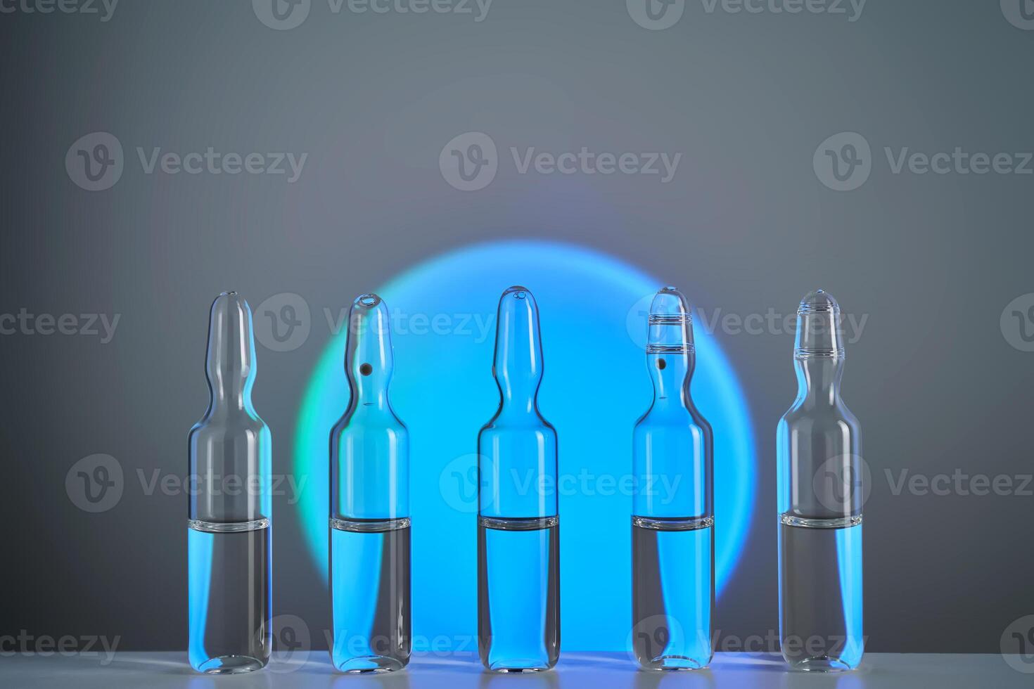 Several ampoules for injection with medicines on a blue background. photo