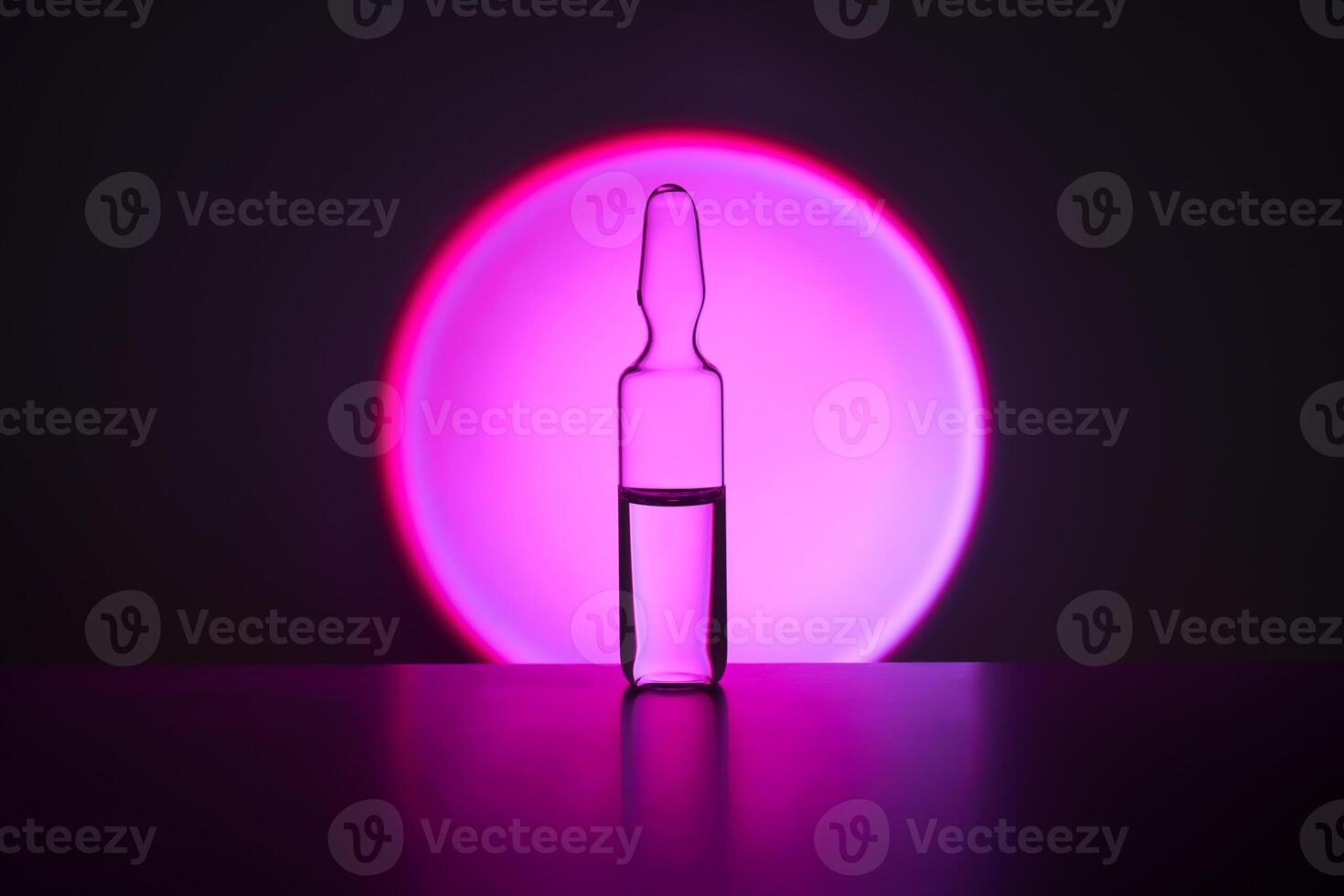 Several ampoules for injection with medicines on a lilac background. photo