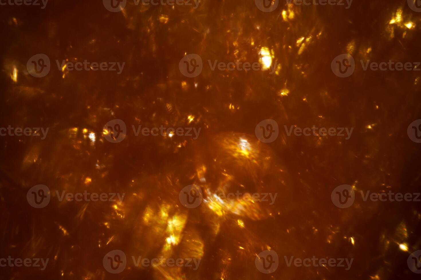 Festive dark gold abstract background with sparkles. photo
