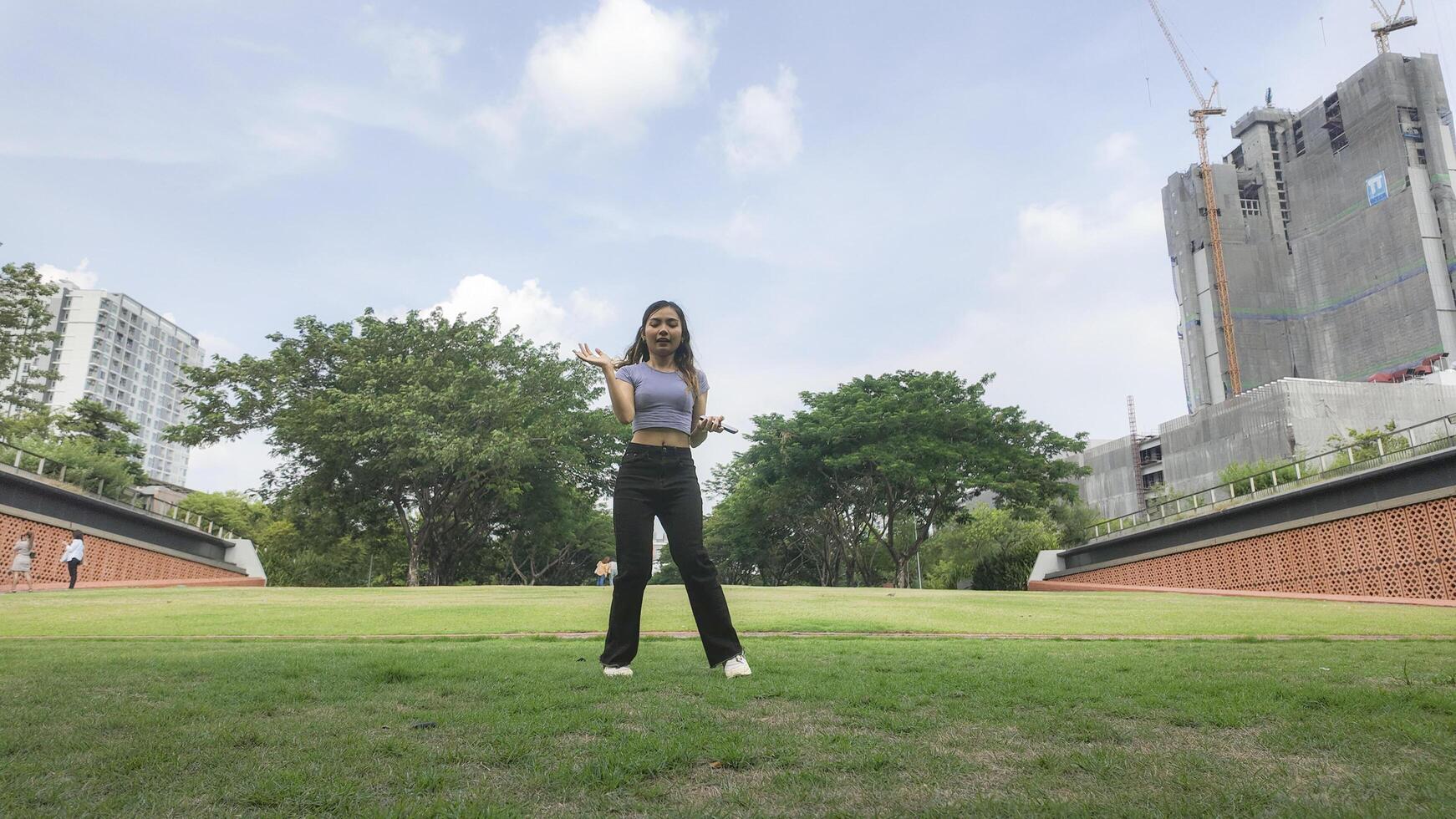 Asian women do freestyle hip hop and breakdancing in a public space in the middle of the city. With a cheerful and happy attitude photo