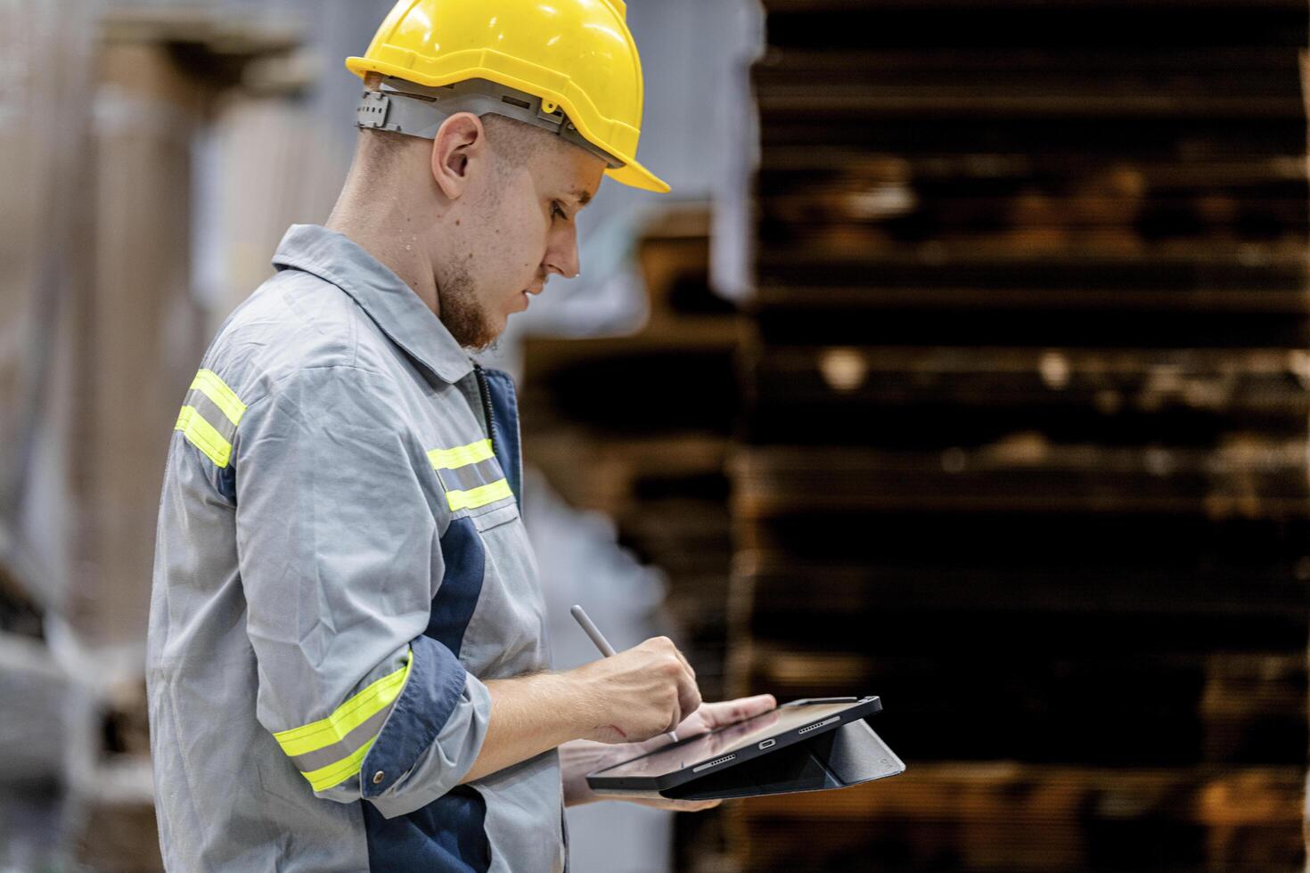 man worker walking and checking stock items for shipping. male inspecting the store factory. Logistics employees holding folders at on site warehouse area for shipping transportation. photo