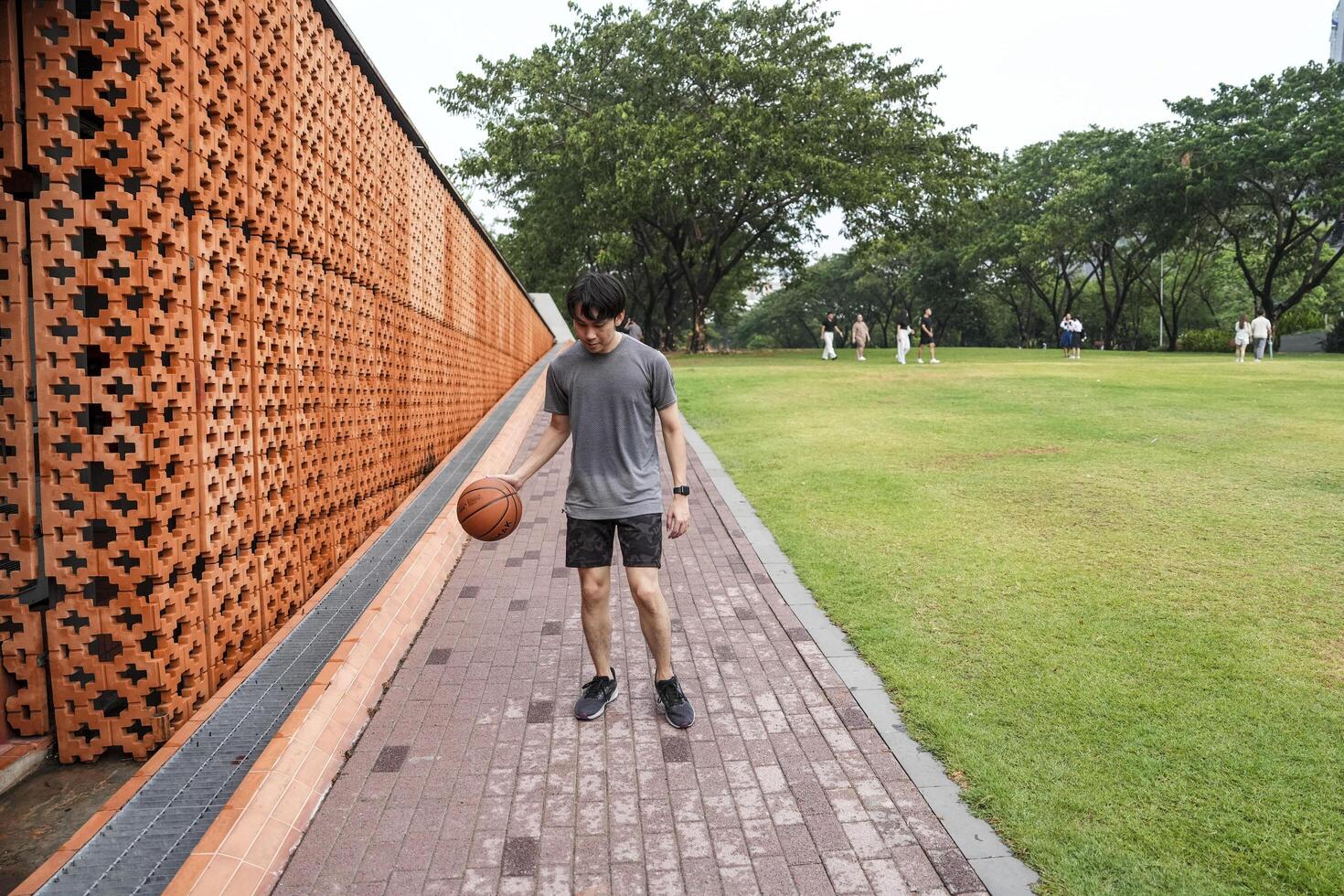 Men take a walk to relax after playing basketball in a public area, having fun and practicing at the same time. photo