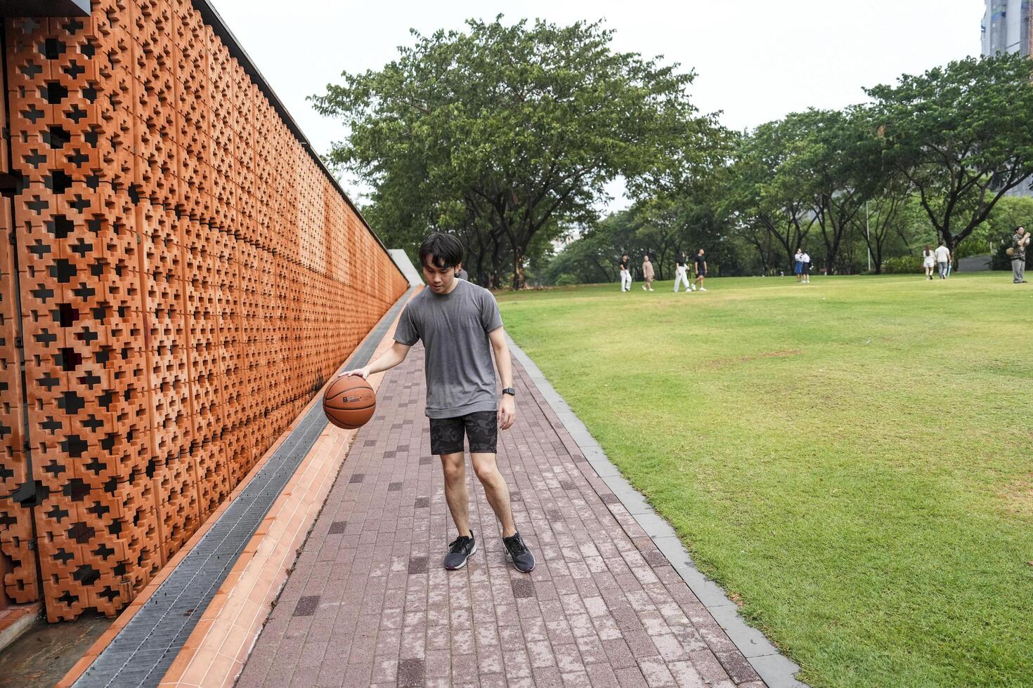 Men take a walk to relax after playing basketball in a public area, having fun and practicing at the same time. photo