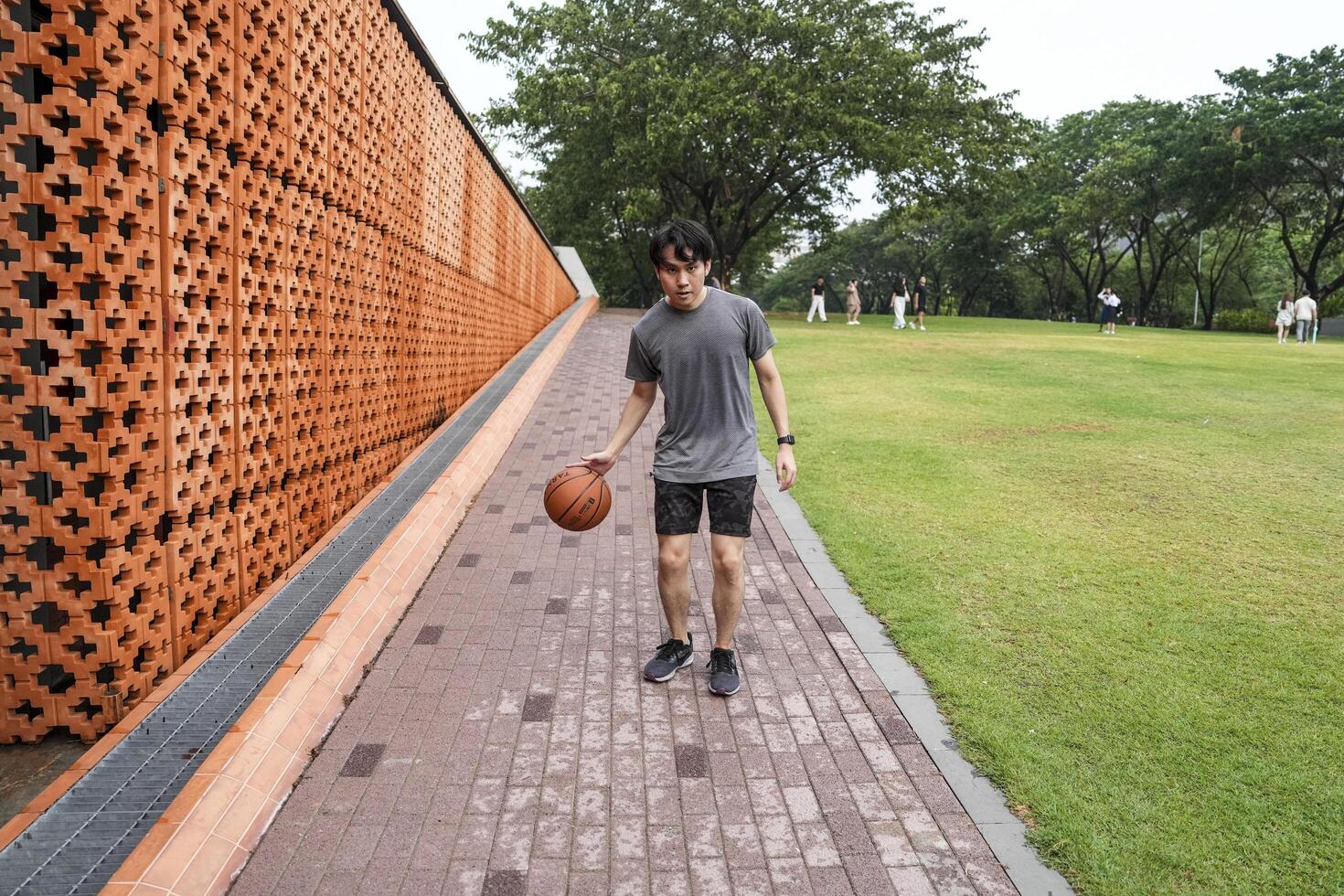 Men take a walk to relax after playing basketball in a public area, having fun and practicing at the same time. photo
