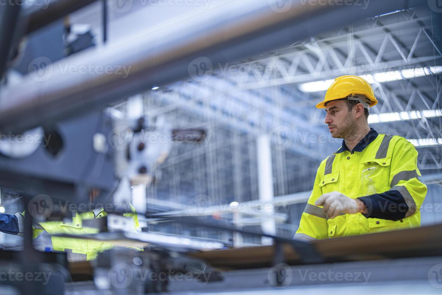 male and female technician engineers checking the process on Heavy machine. mechanical engineering team production. Industry manufacturing. Worker holding tablet and folde. High technology production. photo
