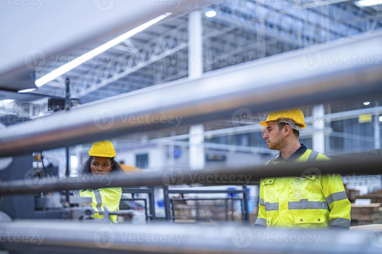 male and female technician engineers checking the process on Heavy machine. mechanical engineering team production. Industry manufacturing. Worker holding tablet and folde. High technology production. photo