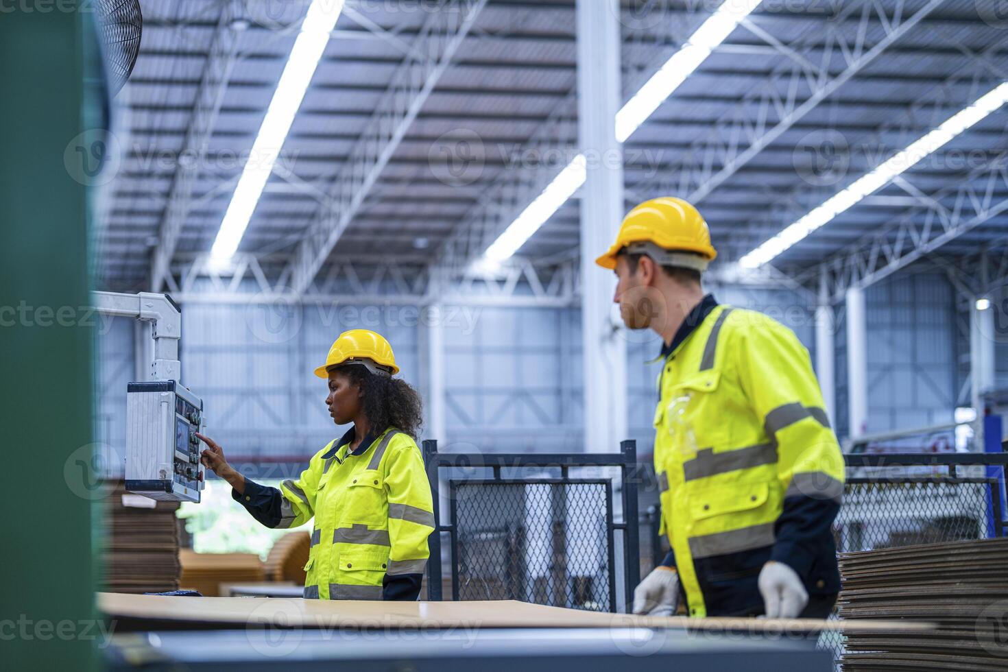 male and female technician engineers checking the process on Heavy machine. mechanical engineering team production. Industry manufacturing. Worker holding tablet and folde. High technology production. photo