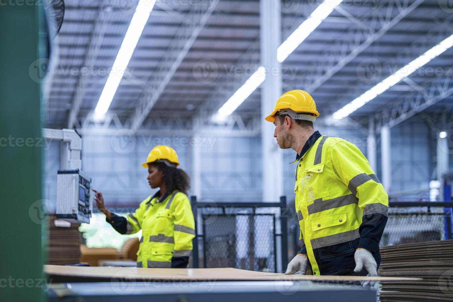 male and female technician engineers checking the process on Heavy machine. mechanical engineering team production. Industry manufacturing. Worker holding tablet and folde. High technology production. photo