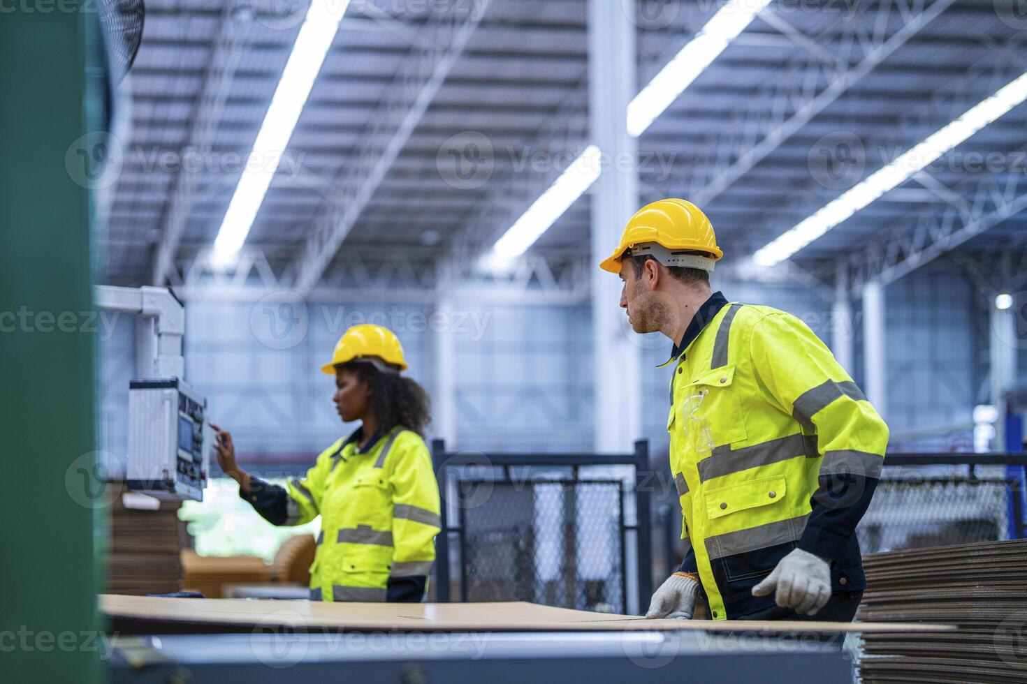 male and female technician engineers checking the process on Heavy machine. mechanical engineering team production. Industry manufacturing. Worker holding tablet and folde. High technology production. photo