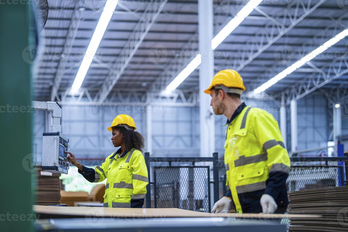 male and female technician engineers checking the process on Heavy machine. mechanical engineering team production. Industry manufacturing. Worker holding tablet and folde. High technology production. photo
