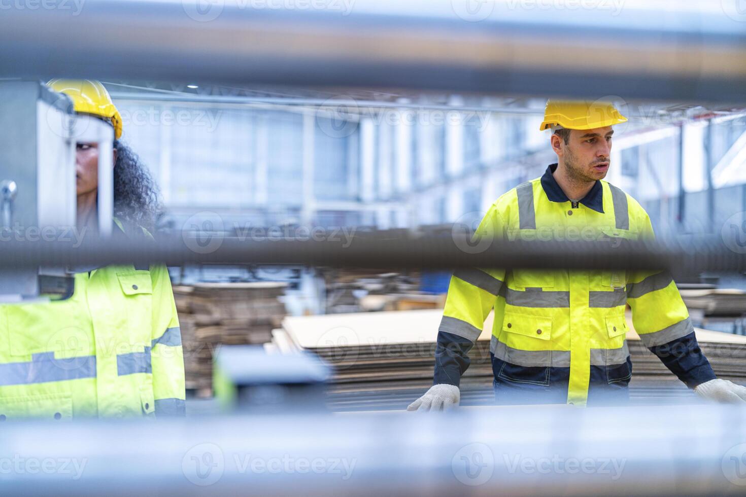 male and female technician engineers checking the process on Heavy machine. mechanical engineering team production. Industry manufacturing. Worker holding tablet and folde. High technology production. photo