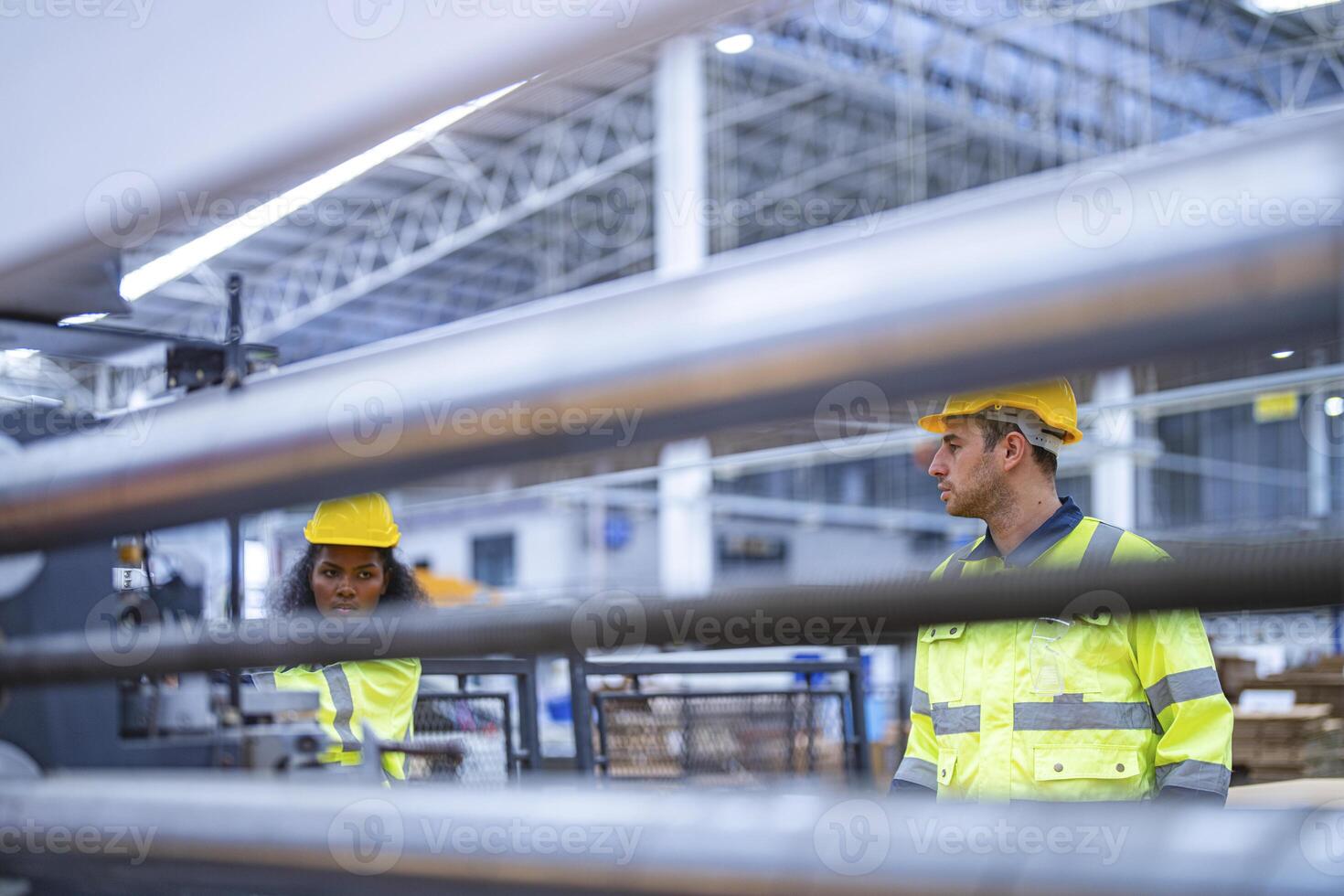 male and female technician engineers checking the process on Heavy machine. mechanical engineering team production. Industry manufacturing. Worker holding tablet and folde. High technology production. photo