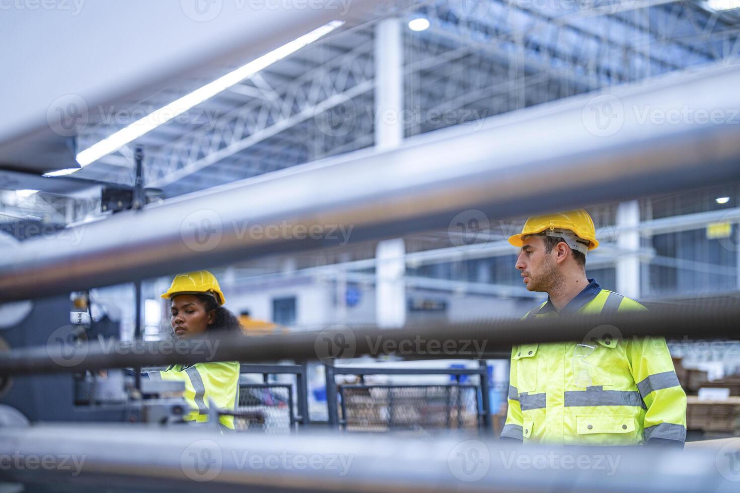 male and female technician engineers checking the process on Heavy machine. mechanical engineering team production. Industry manufacturing. Worker holding tablet and folde. High technology production. photo