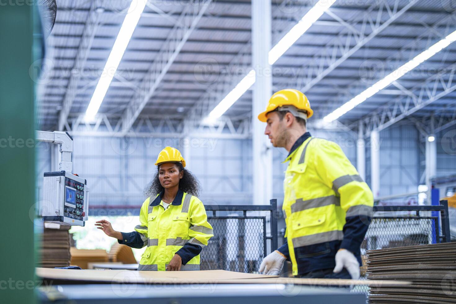 male and female technician engineers checking the process on Heavy machine. mechanical engineering team production. Industry manufacturing. Worker holding tablet and folde. High technology production. photo