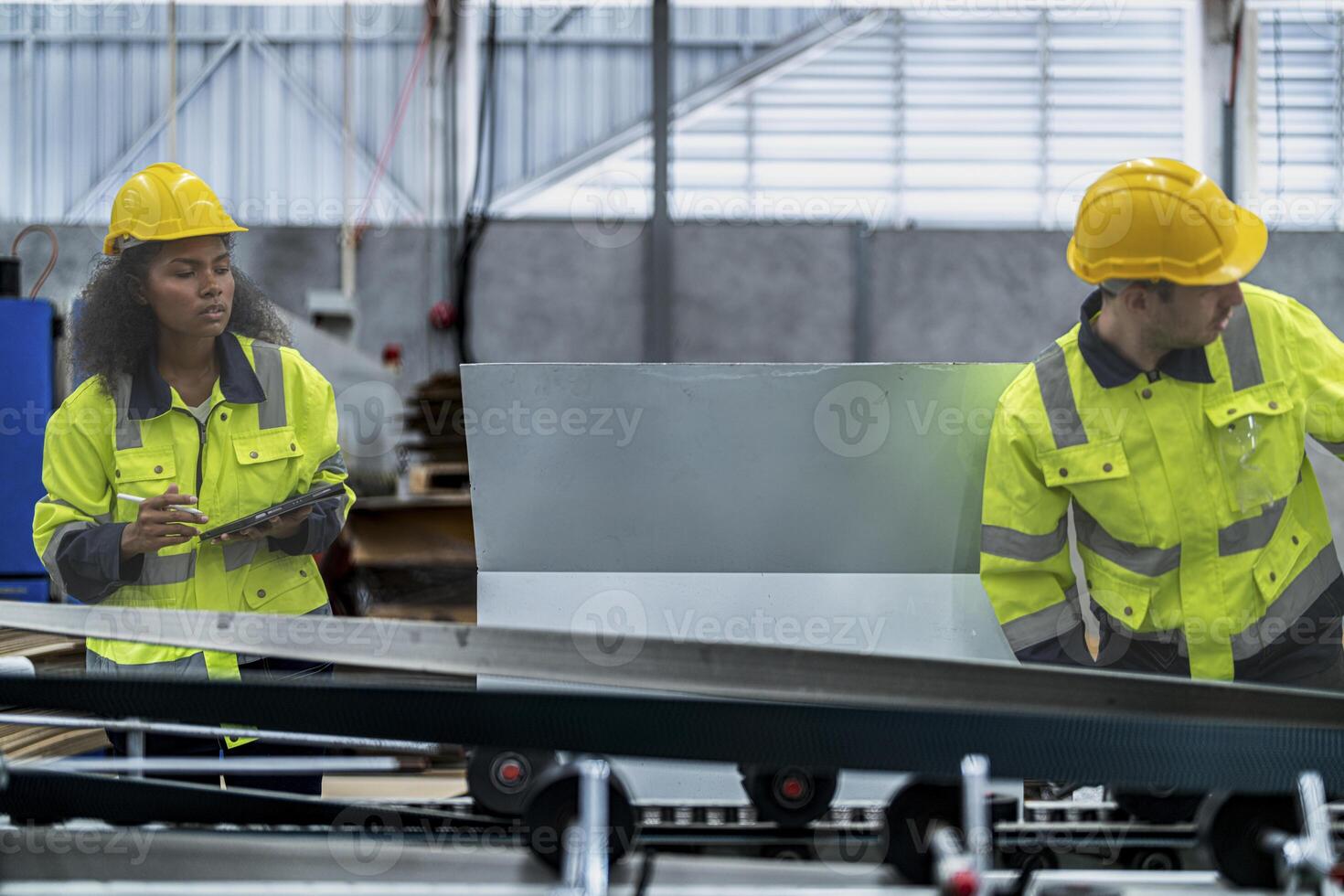 male and female technician engineers checking the process on Heavy machine. mechanical engineering team production. Industry manufacturing. Worker holding tablet and folde. High technology production. photo