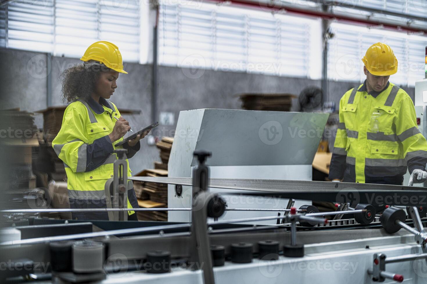 male and female technician engineers checking the process on Heavy machine. mechanical engineering team production. Industry manufacturing. Worker holding tablet and folde. High technology production. photo