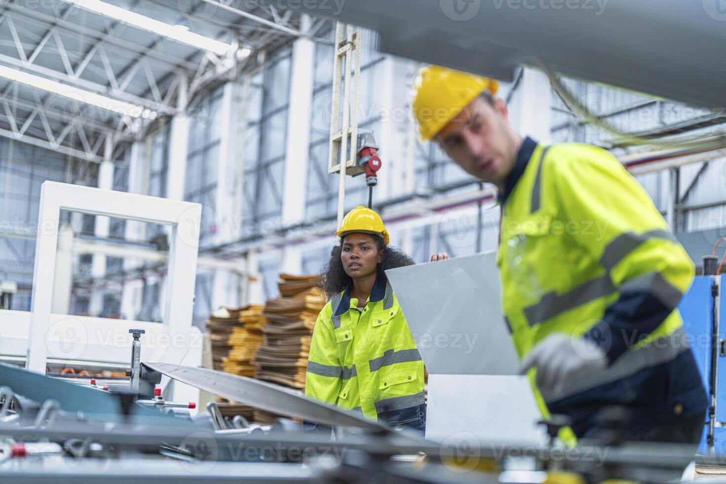 male and female technician engineers checking the process on Heavy machine. mechanical engineering team production. Industry manufacturing. Worker holding tablet and folde. High technology production. photo