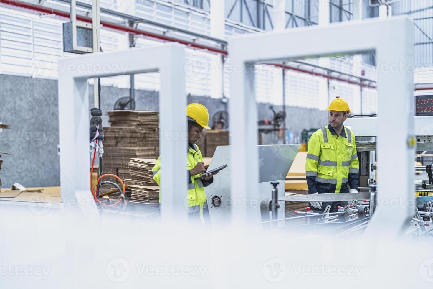 male and female technician engineers checking the process on Heavy machine. mechanical engineering team production. Industry manufacturing. Worker holding tablet and folde. High technology production. photo