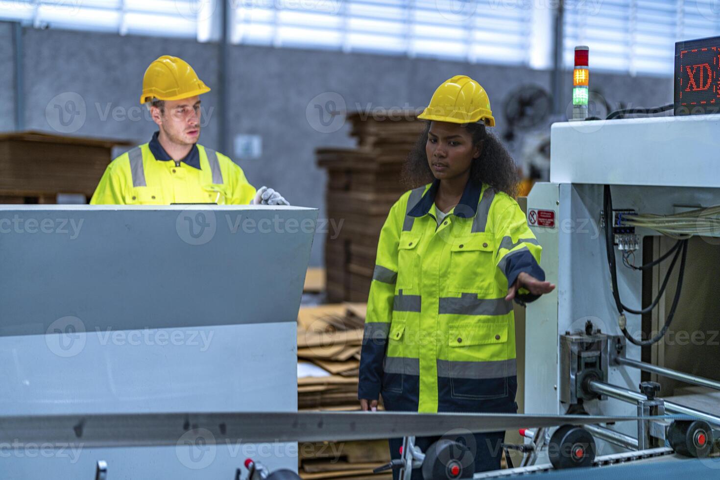 male and female technician engineers checking the process on Heavy machine. mechanical engineering team production. Industry manufacturing. Worker holding tablet and folde. High technology production. photo