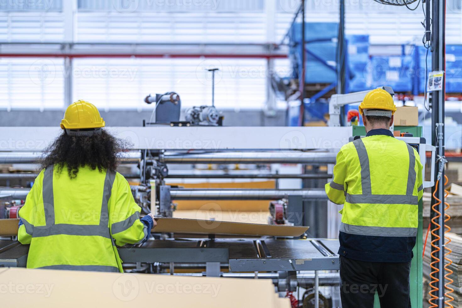 male and female technician engineers checking the process on Heavy machine. mechanical engineering team production. Industry manufacturing. Worker holding tablet and folde. High technology production. photo