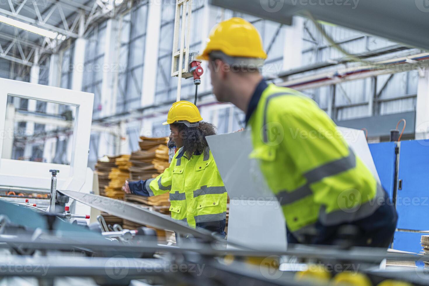 male and female technician engineers checking the process on Heavy machine. mechanical engineering team production. Industry manufacturing. Worker holding tablet and folde. High technology production. photo