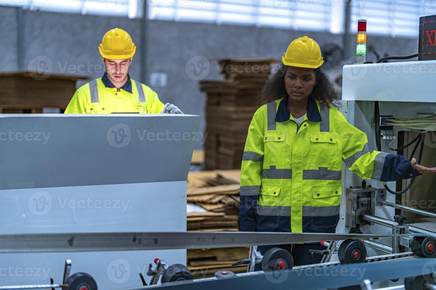 male and female technician engineers checking the process on Heavy machine. mechanical engineering team production. Industry manufacturing. Worker holding tablet and folde. High technology production. photo