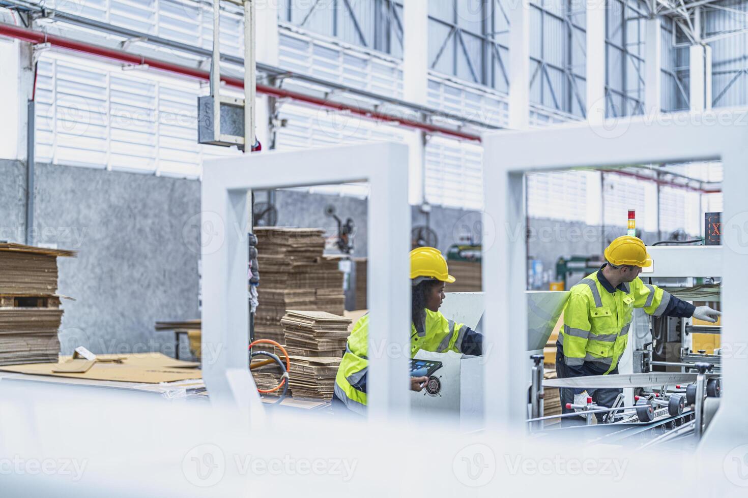 male and female technician engineers checking the process on Heavy machine. mechanical engineering team production. Industry manufacturing. Worker holding tablet and folde. High technology production. photo