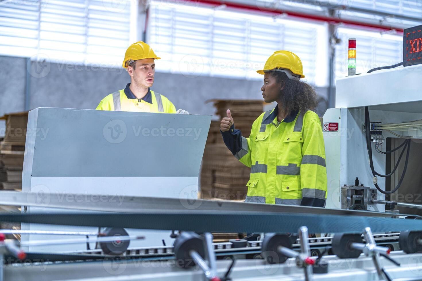 male and female technician engineers checking the process on Heavy machine. mechanical engineering team production. Industry manufacturing. Worker holding tablet and folde. High technology production. photo