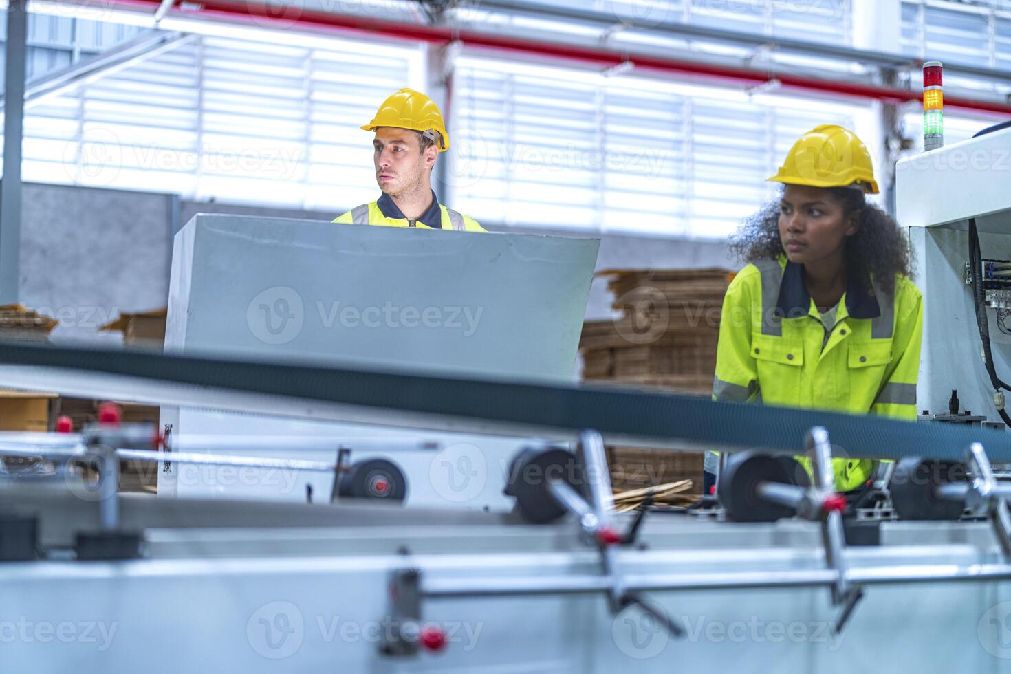 male and female technician engineers checking the process on Heavy machine. mechanical engineering team production. Industry manufacturing. Worker holding tablet and folde. High technology production. photo