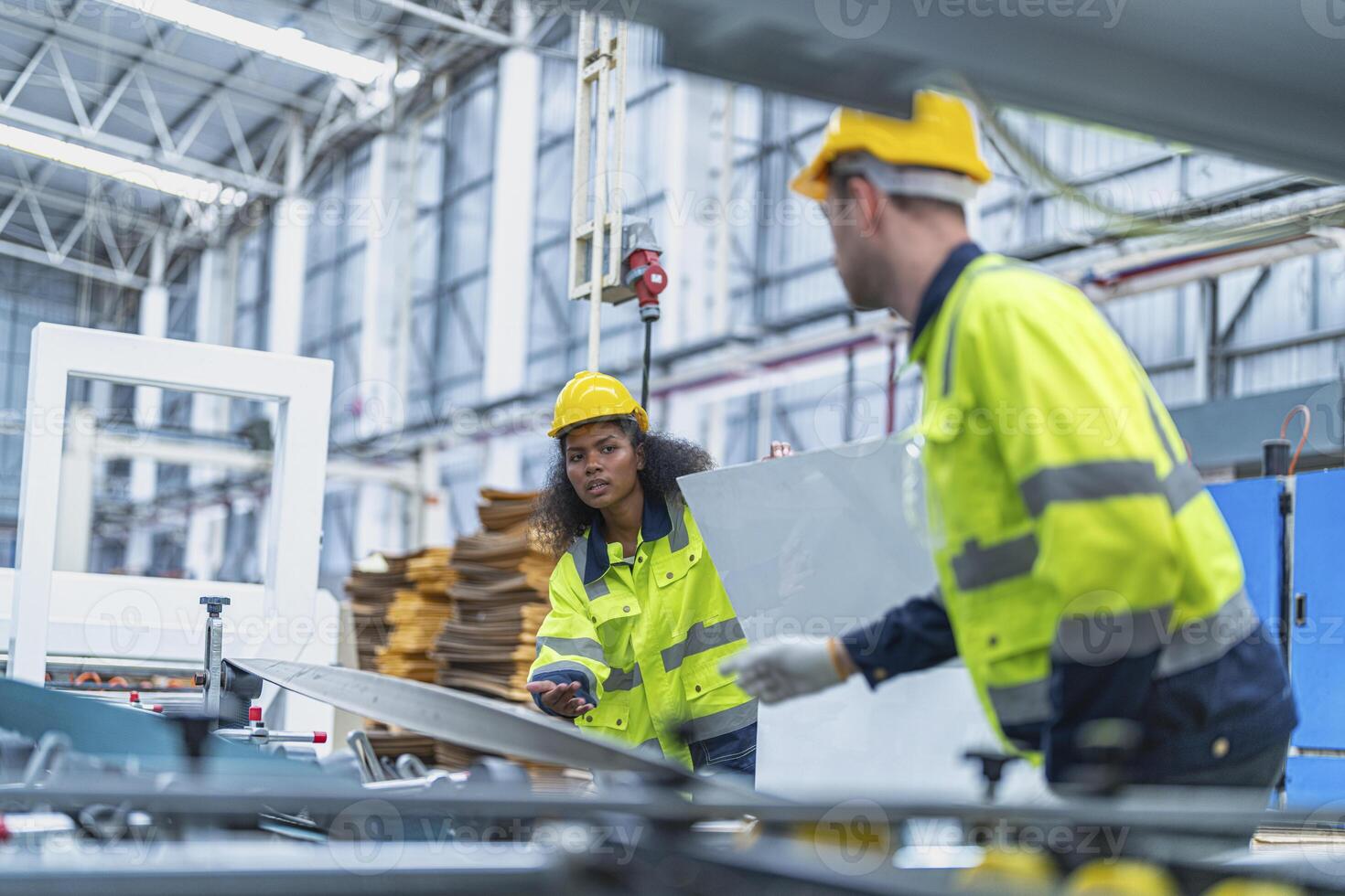 male and female technician engineers checking the process on Heavy machine. mechanical engineering team production. Industry manufacturing. Worker holding tablet and folde. High technology production. photo
