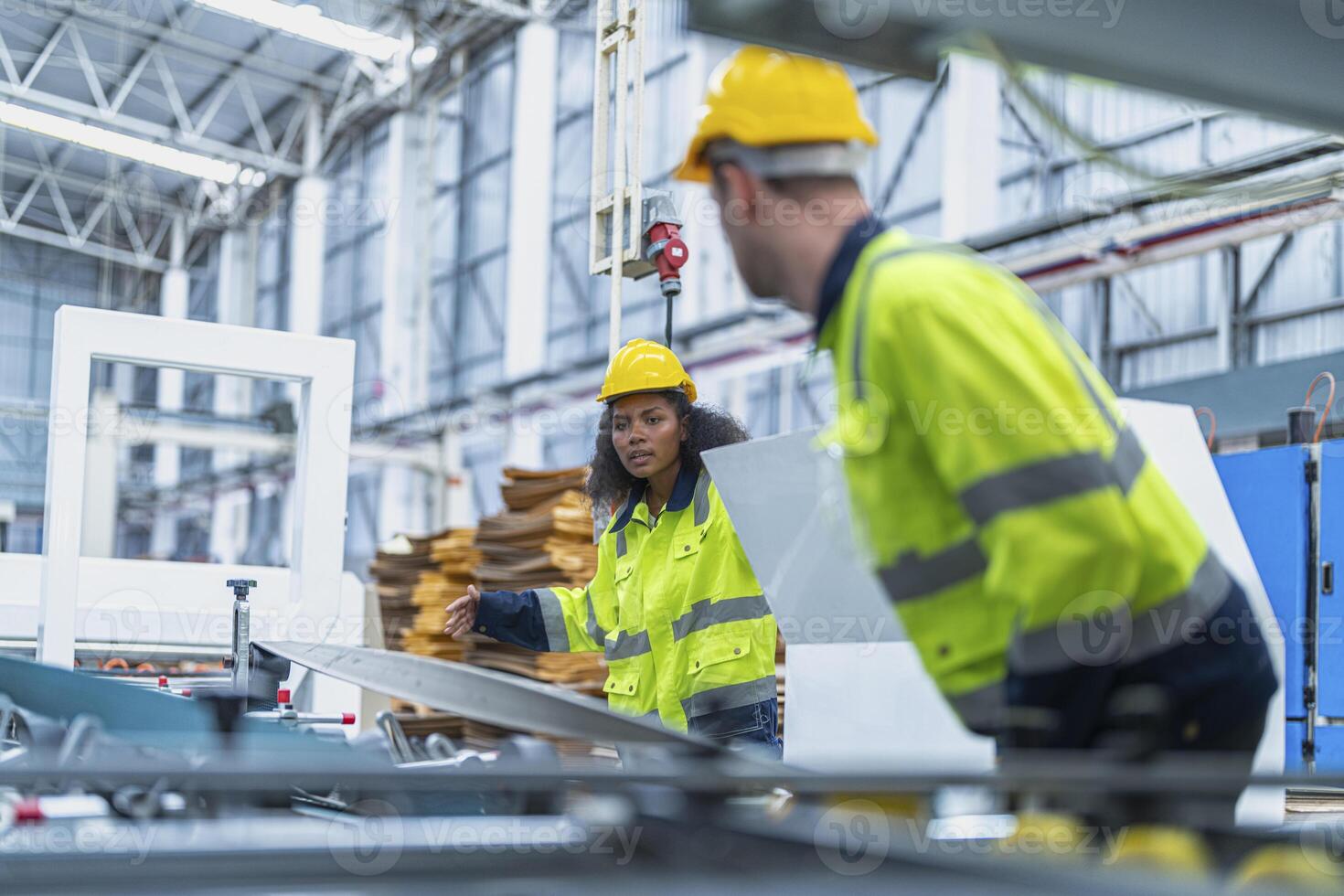 male and female technician engineers checking the process on Heavy machine. mechanical engineering team production. Industry manufacturing. Worker holding tablet and folde. High technology production. photo