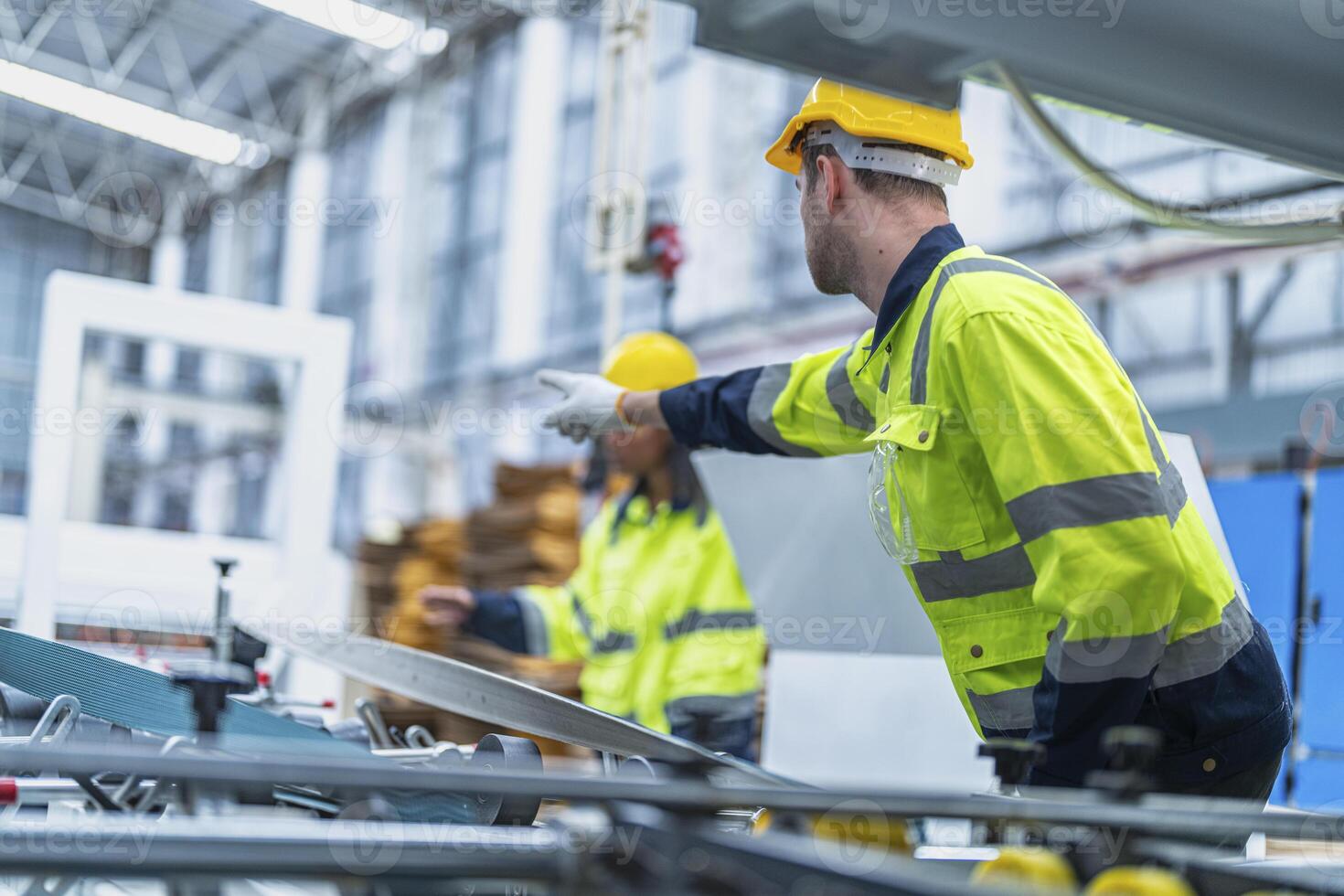 male and female technician engineers checking the process on Heavy machine. mechanical engineering team production. Industry manufacturing. Worker holding tablet and folde. High technology production. photo