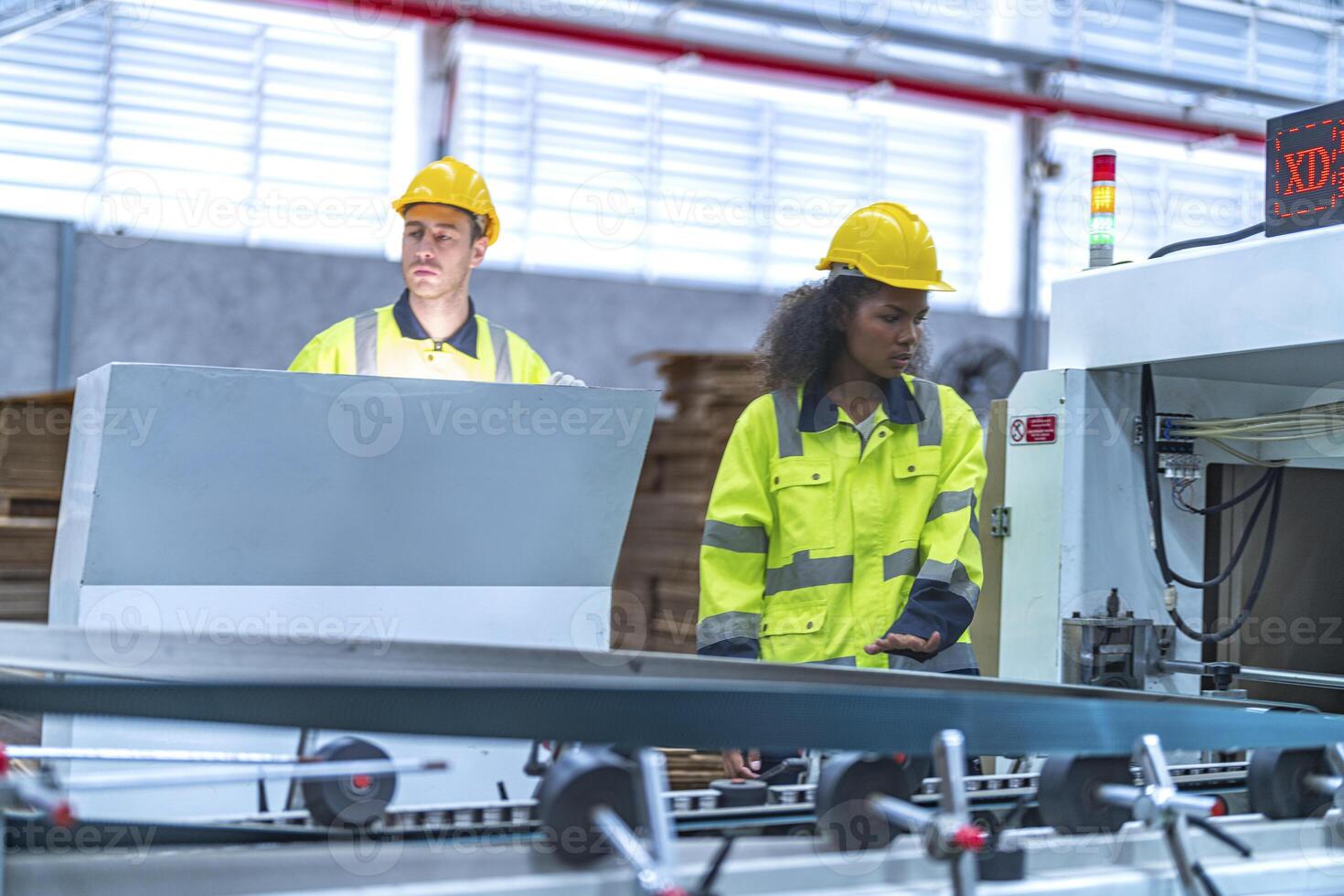 male and female technician engineers checking the process on Heavy machine. mechanical engineering team production. Industry manufacturing. Worker holding tablet and folde. High technology production. photo
