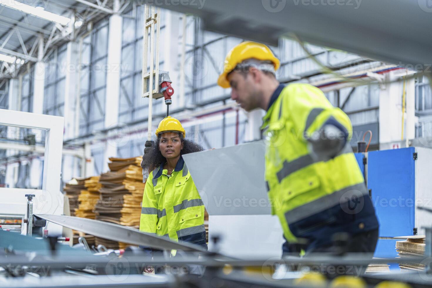 male and female technician engineers checking the process on Heavy machine. mechanical engineering team production. Industry manufacturing. Worker holding tablet and folde. High technology production. photo