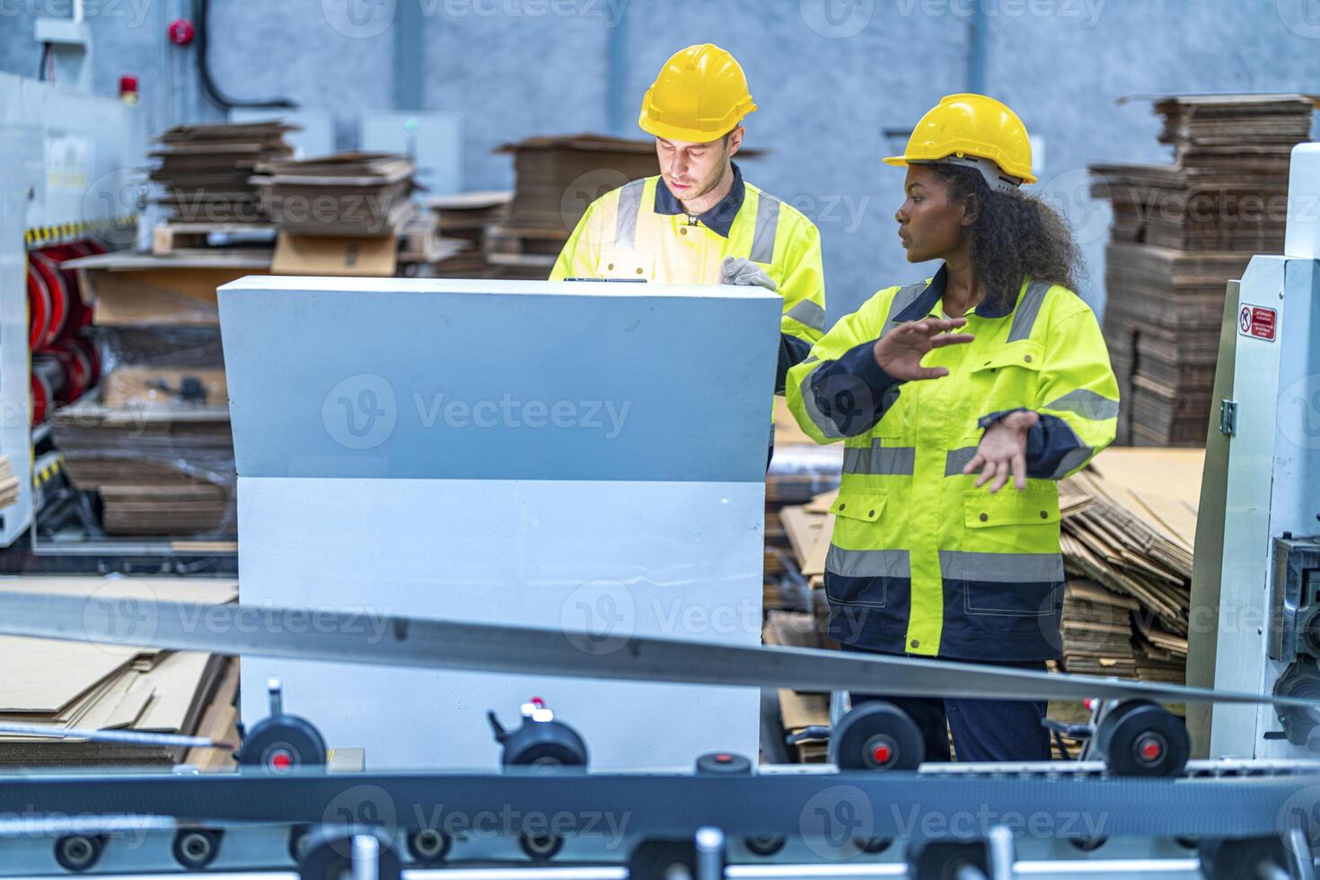 male and female technician engineers checking the process on Heavy machine. mechanical engineering team production. Industry manufacturing. Worker holding tablet and folde. High technology production. photo
